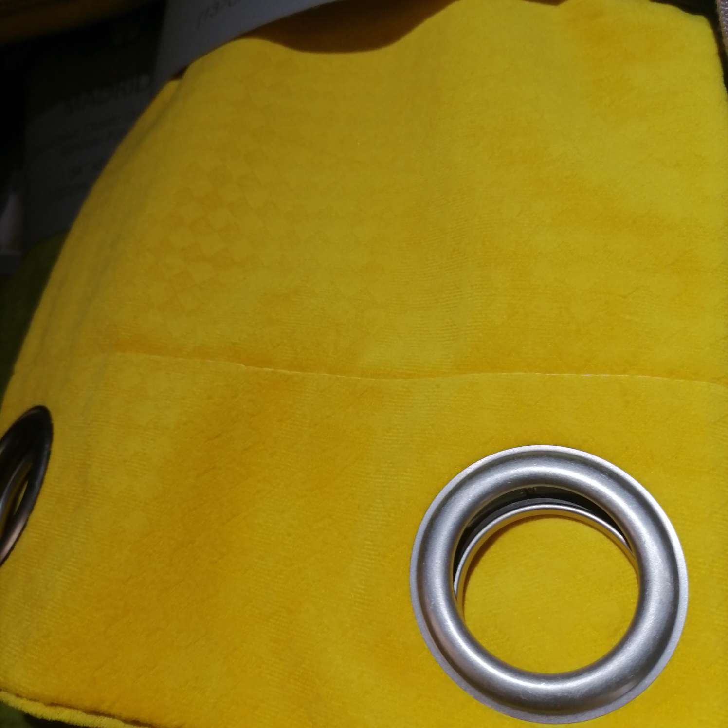 The perforated curtain fabric is bright yellow