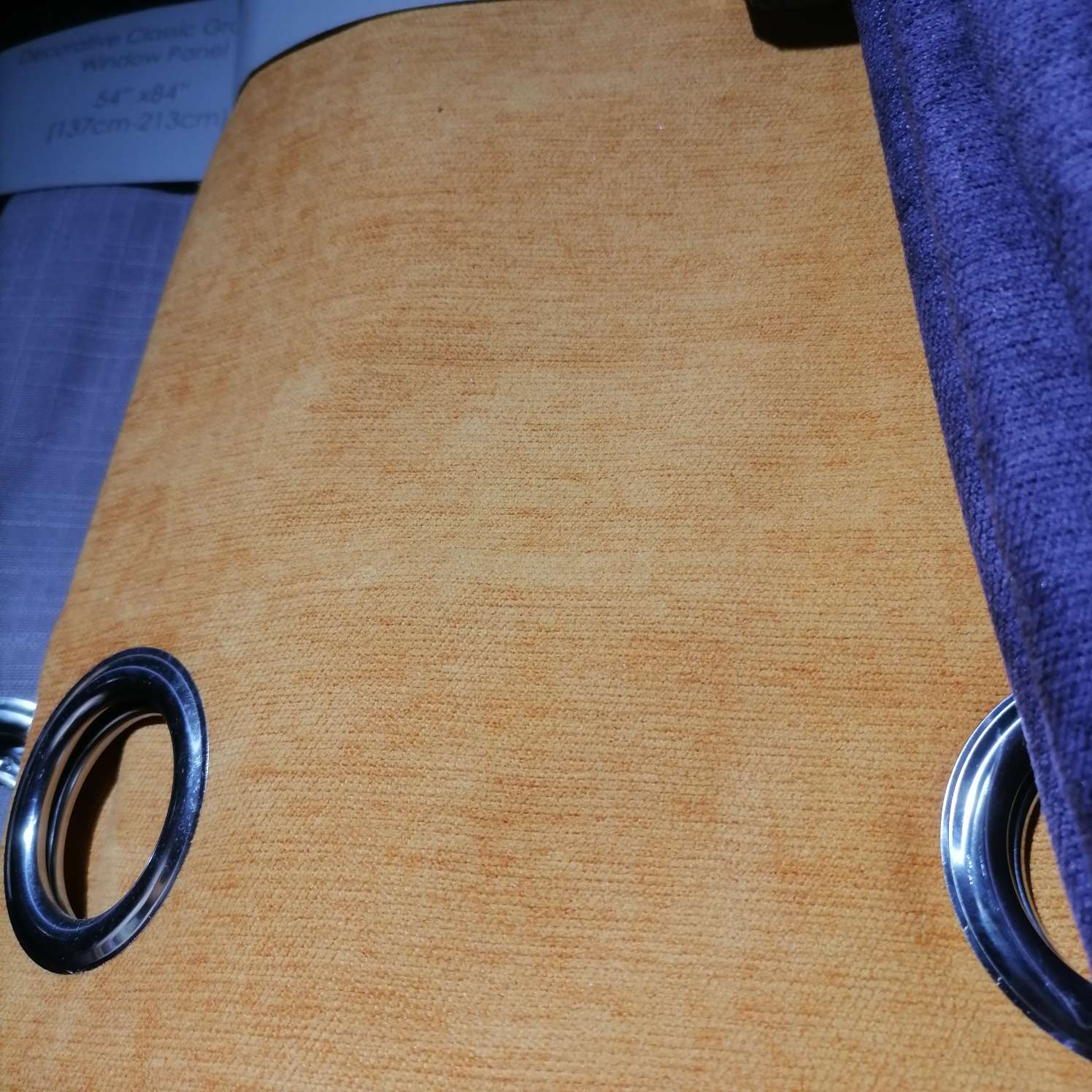 The perforated curtain fabric is dark brown