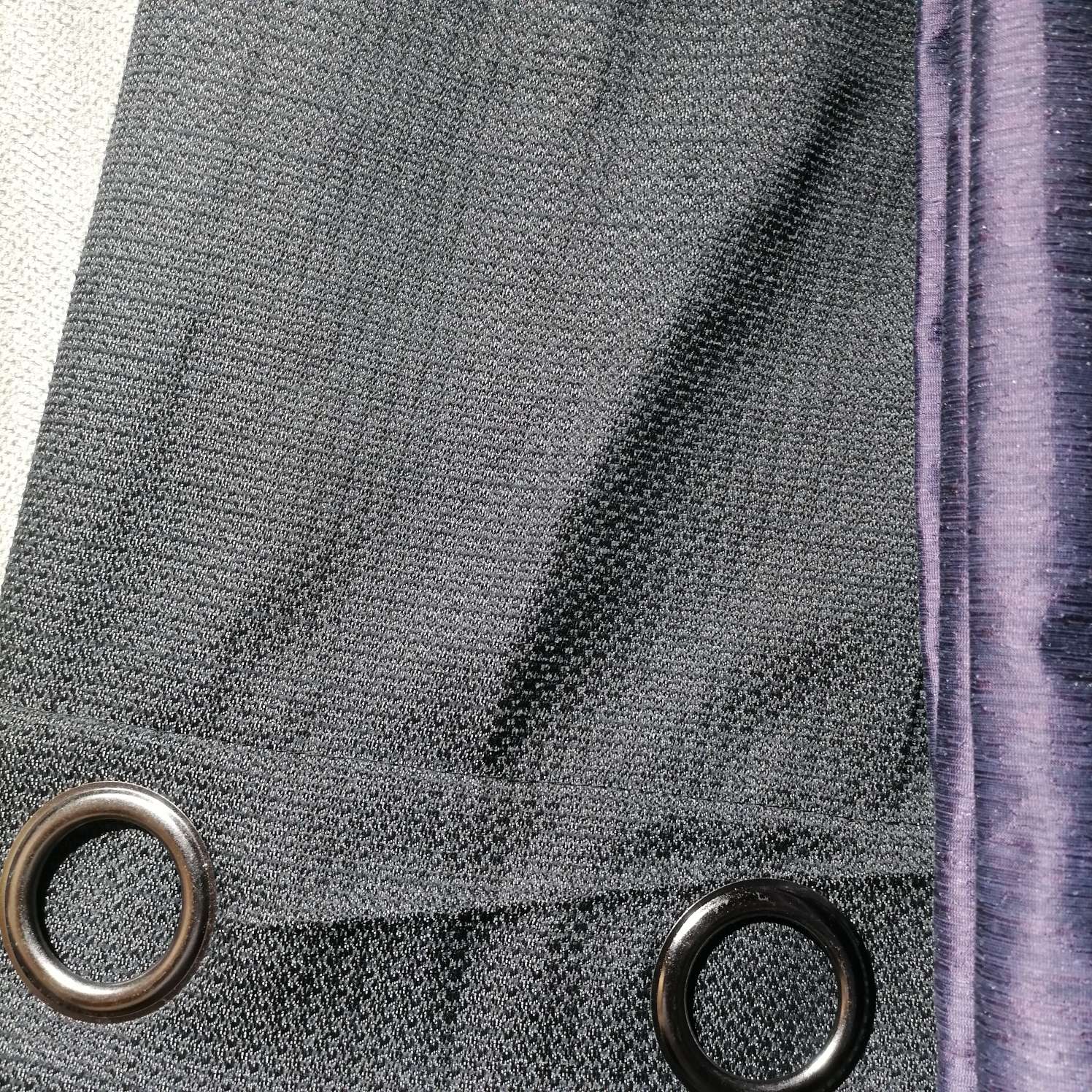 The perforated curtains are dark grey
