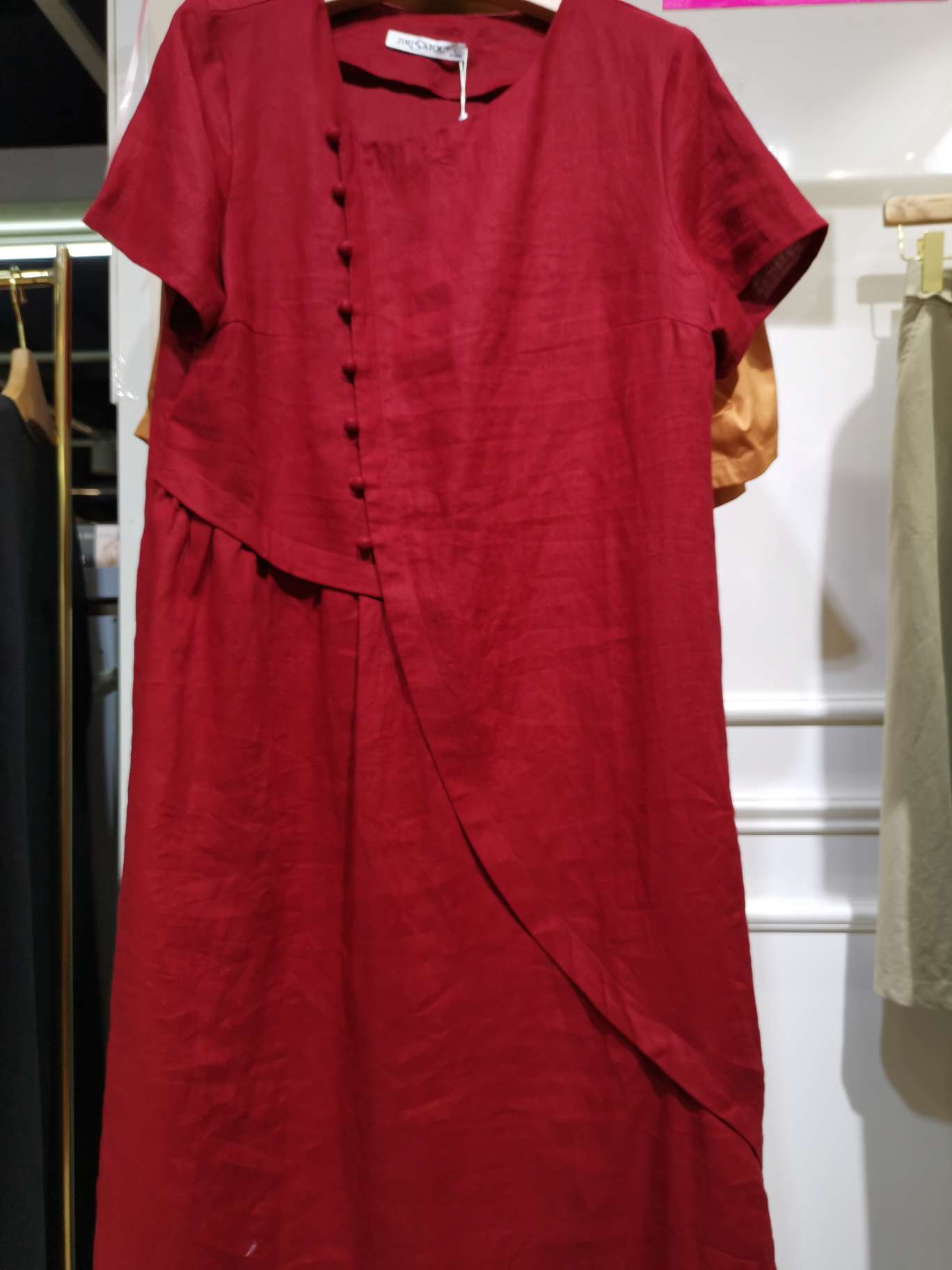 A fashionable red side-button women's dress with a large Y-neck