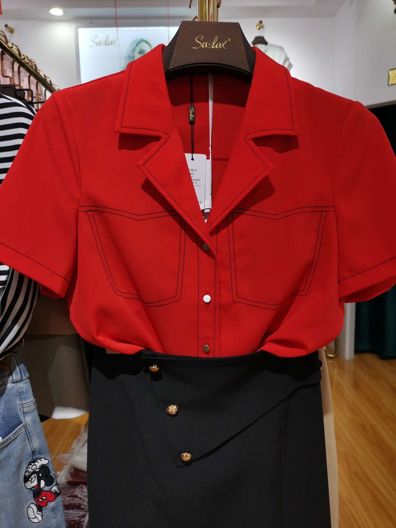 A bright red women's top with a V-neck and clear lines