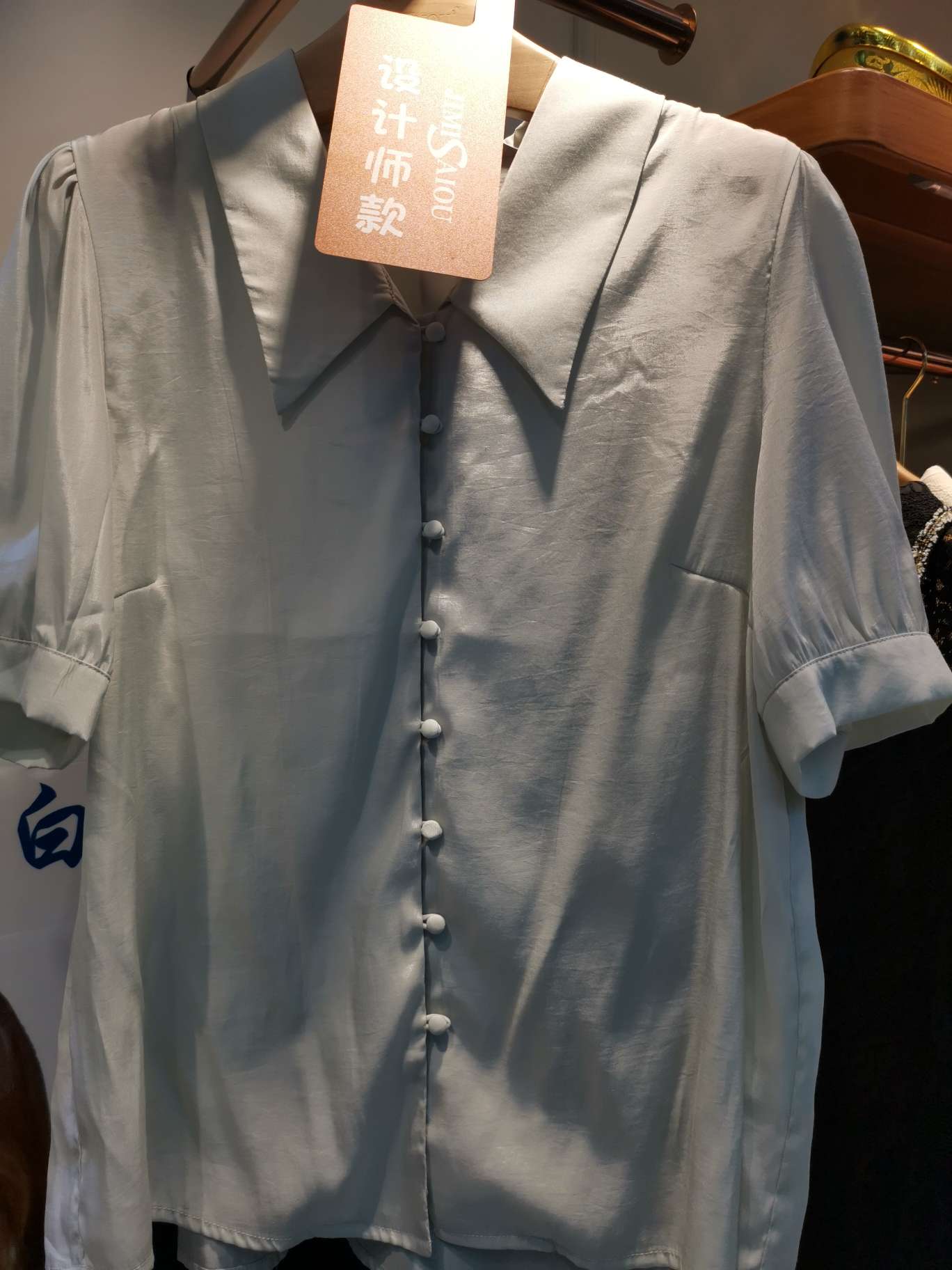 A fashionable single-breasted women's top with a pointed lapel