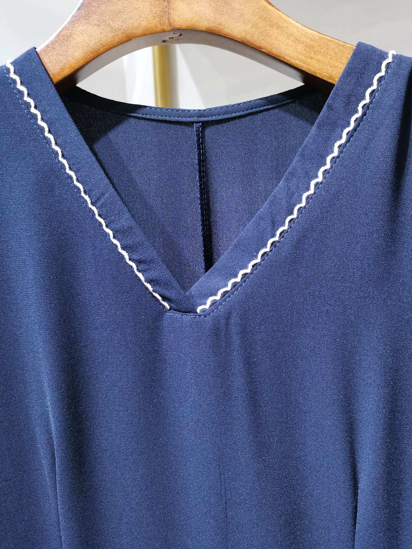 A fashionable V-neck cinched women's dress in bright blue with clear lines details Picture