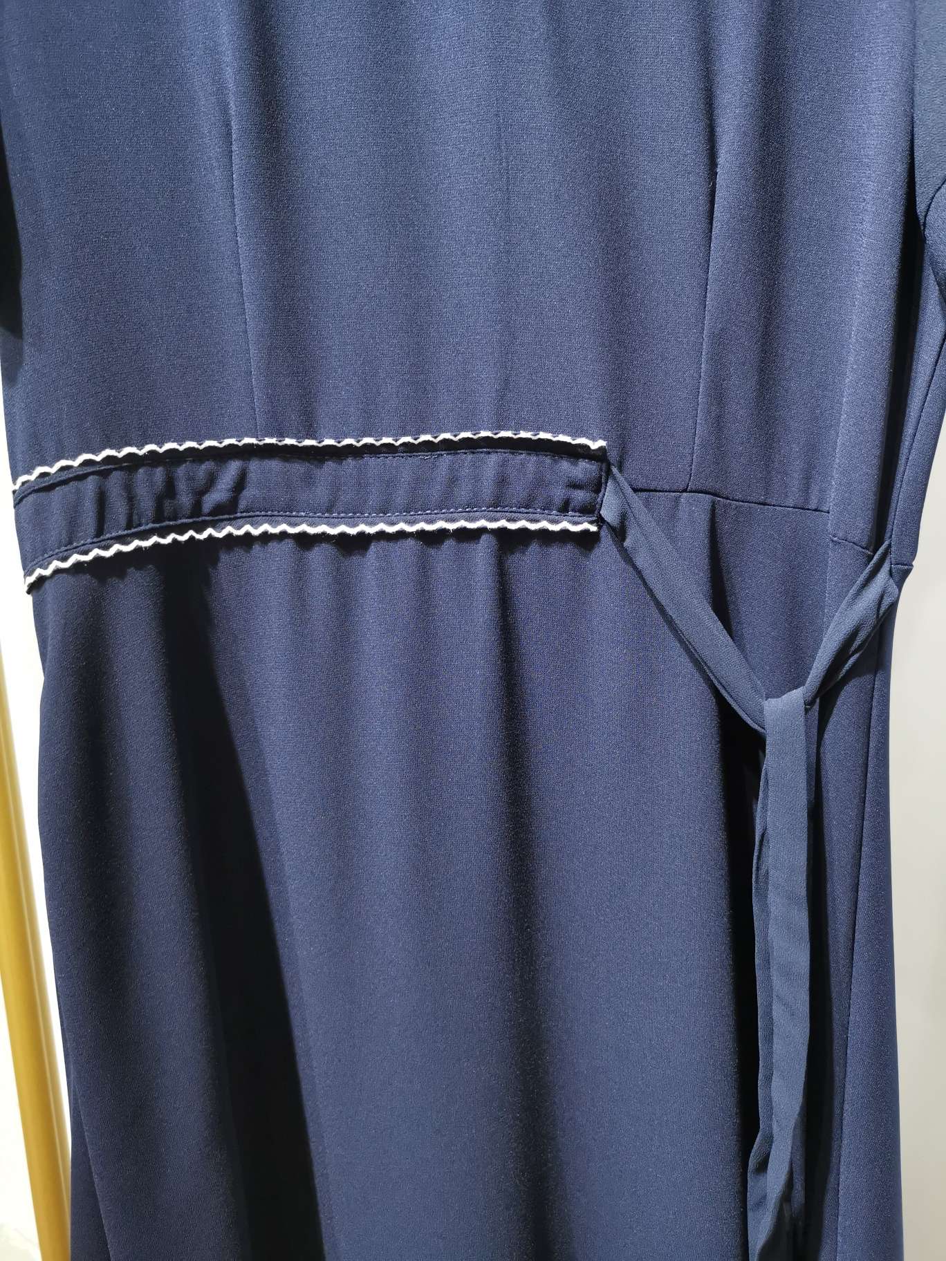 A fashionable V-neck cinched women's dress in bright blue with clear lines Application Scenario