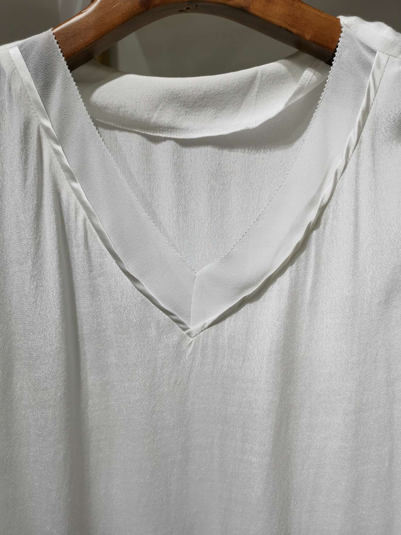 A white double V-neck fashionable casual shirt details Picture