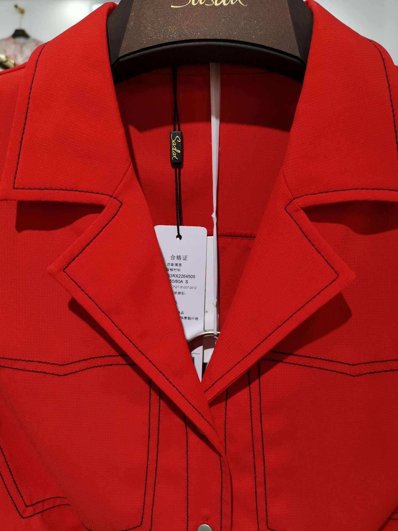 A bright red women's top with a V-neck and clear lines details Picture