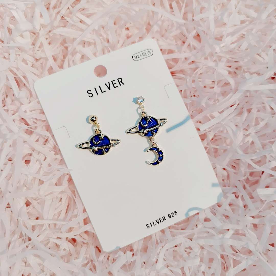 The blue planet Moon Zircon Earrings have an asymmetrical design