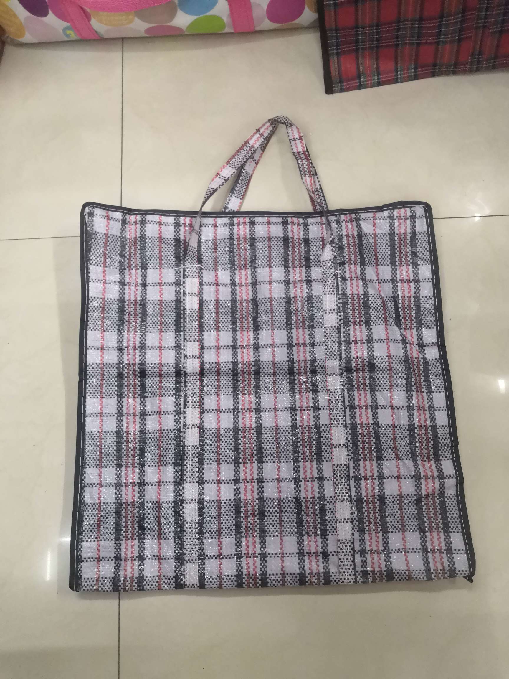 Black and red checkered woven bag