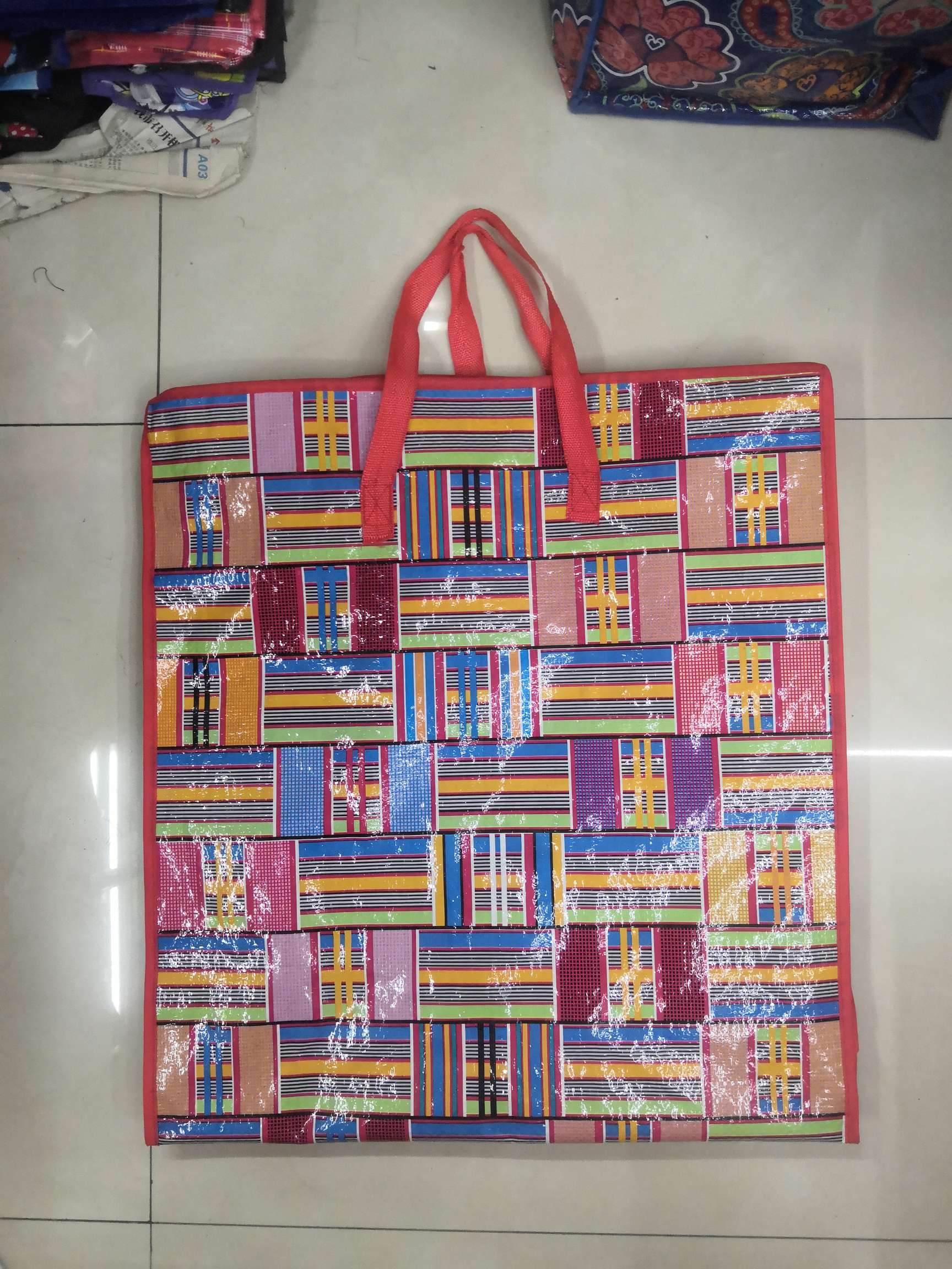Red-rimmed colored woven bags with vertical stripes