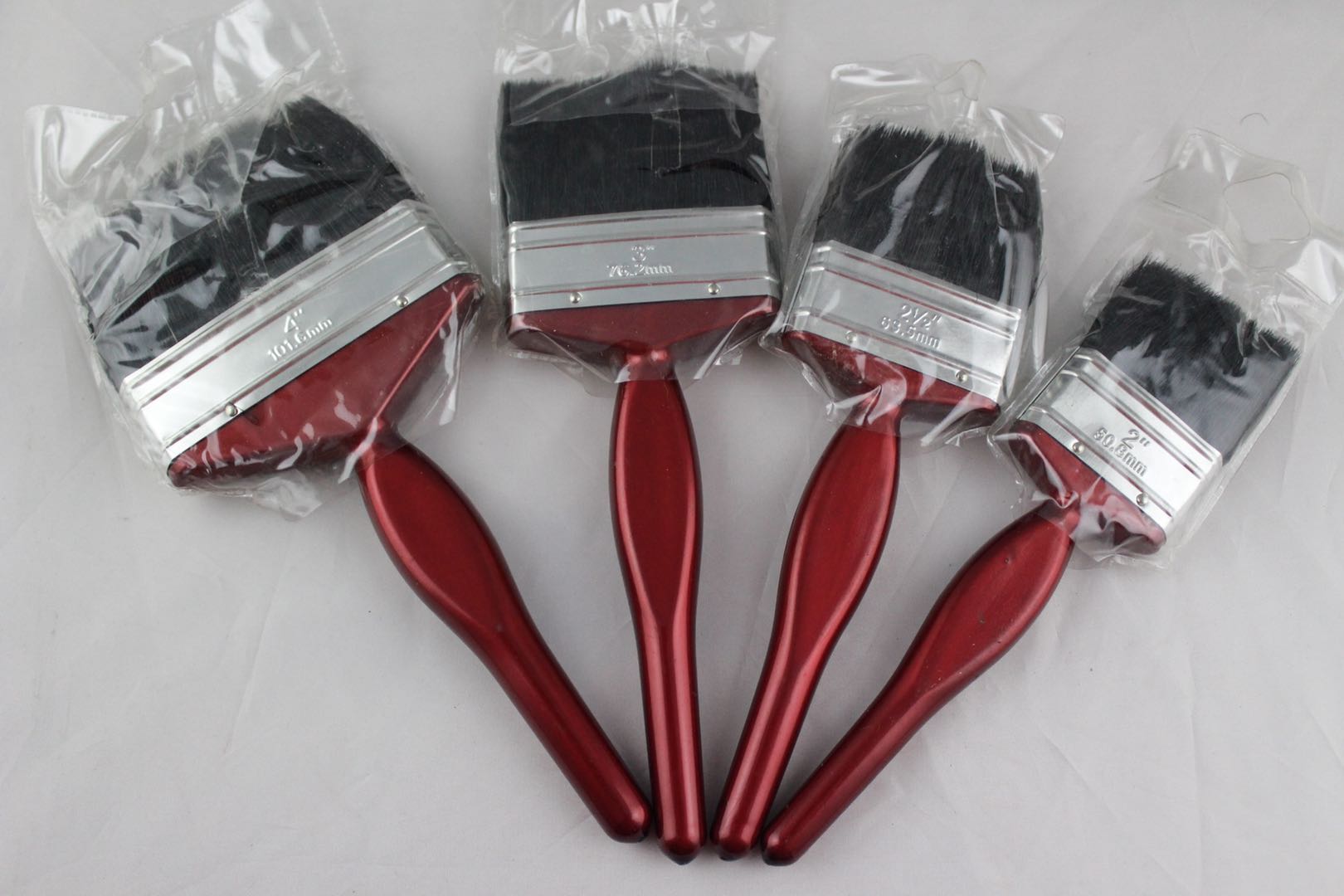 Three-inch red-handled paint brush