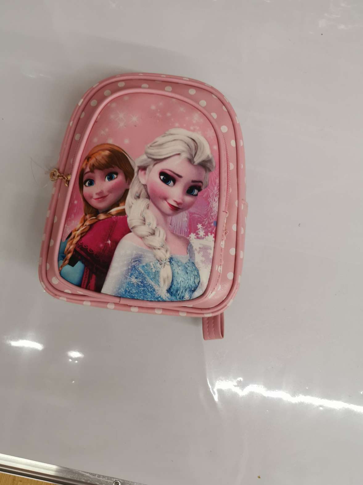 A little girl's oil-leather ice and snow schoolbag
