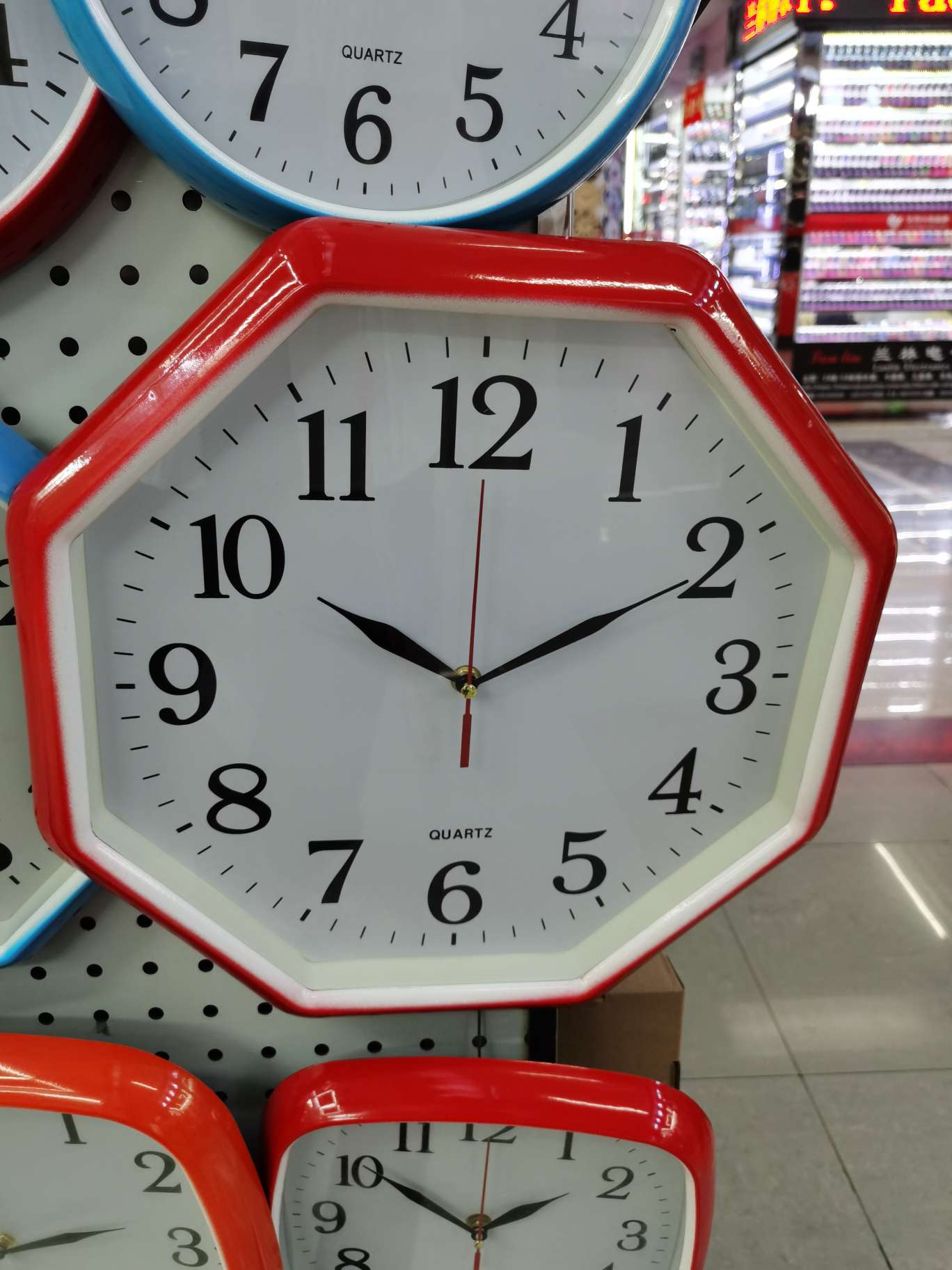 A red diamond-shaped wall clock