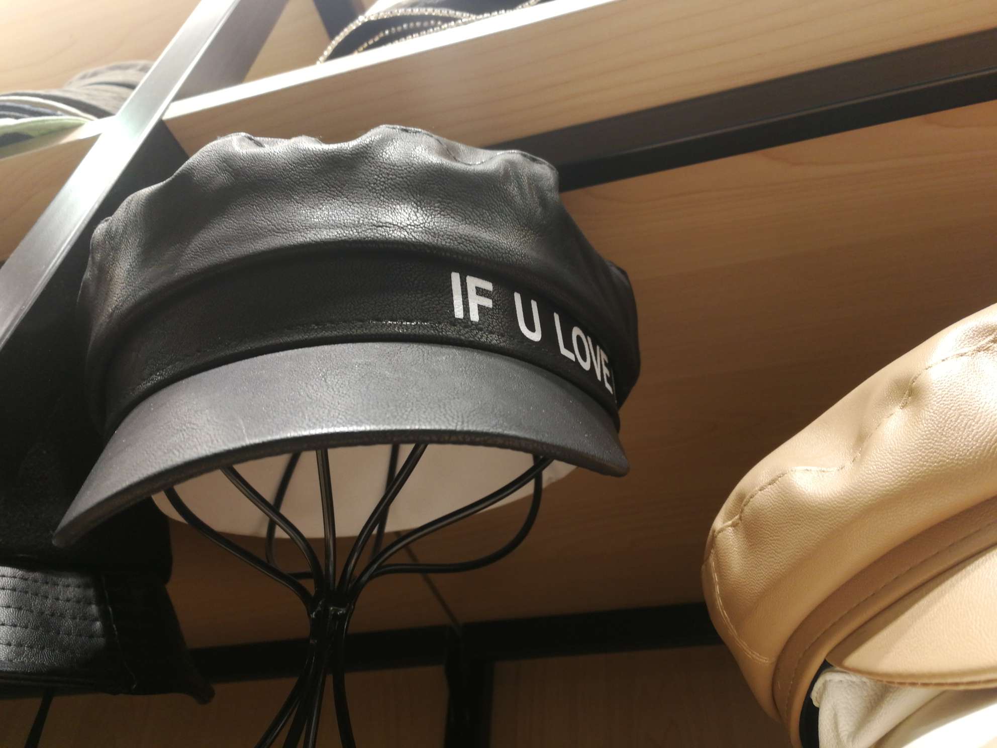 The leather military cap is printed with letters