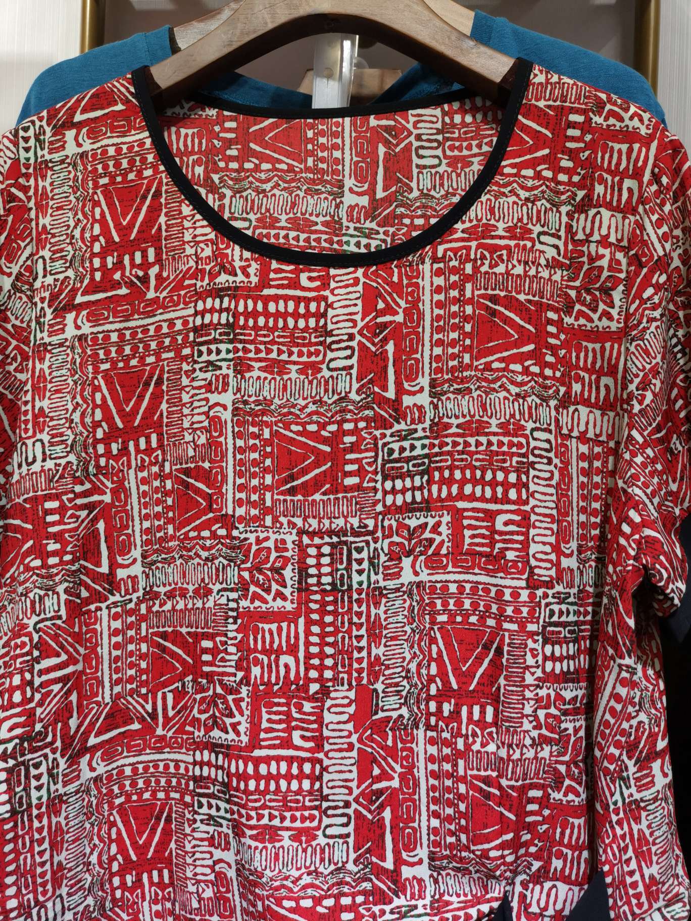 A fashionable casual shirt in bright black with a large round neck