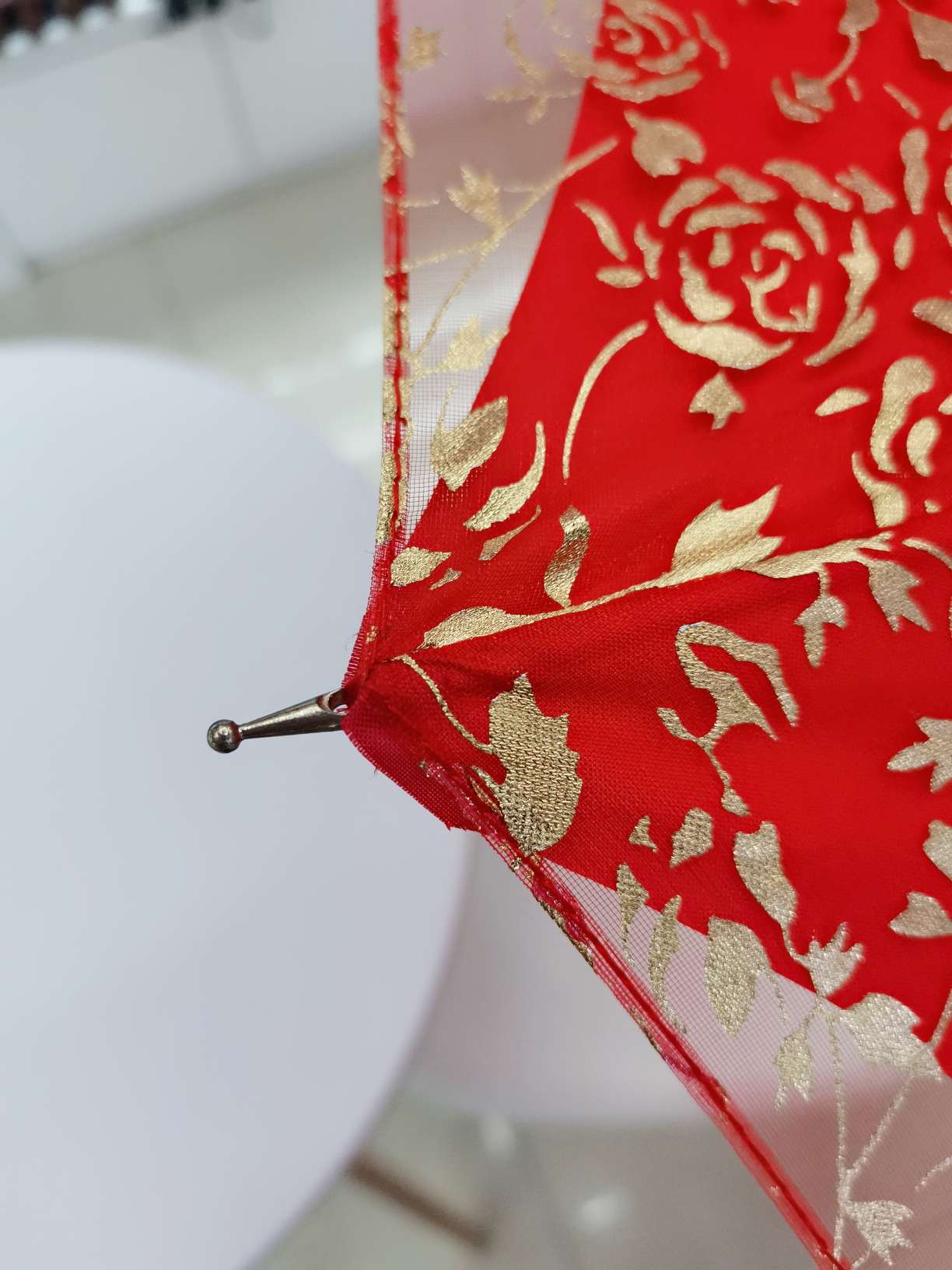 The bride's umbrella is a full sheet of gold-threaded embroidered wedding umbrella and a big red umbrella undefined