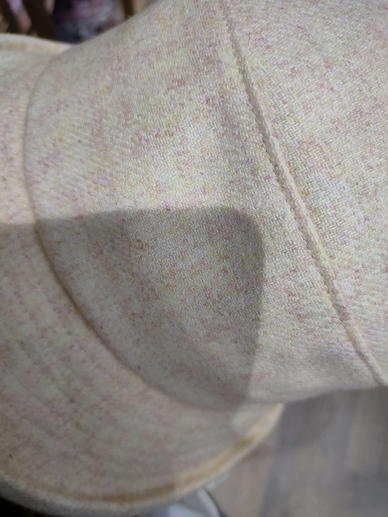 The plain hat is beige detail image 2