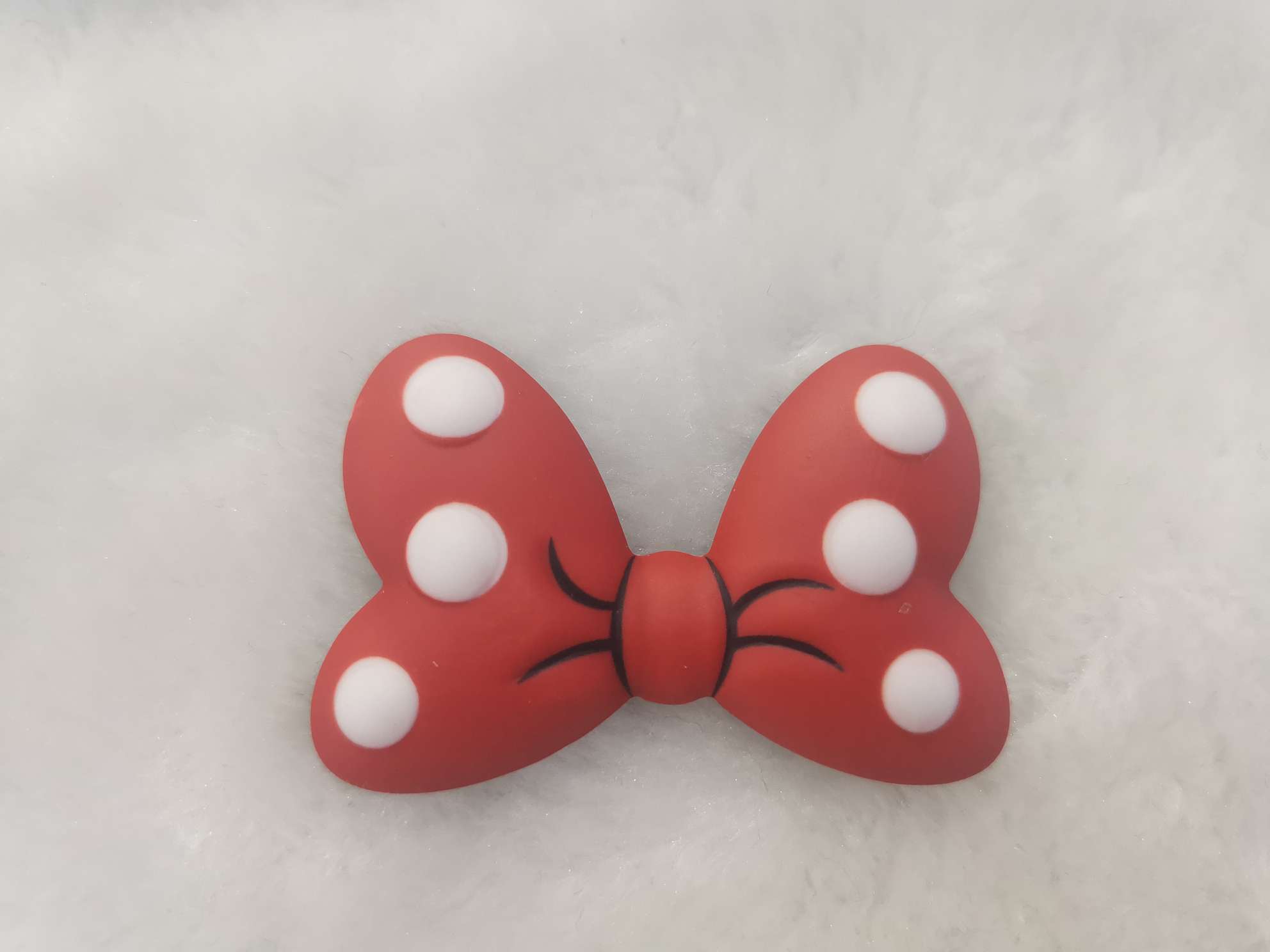 Red bow tie, a popular acrylic accessory on the Internet