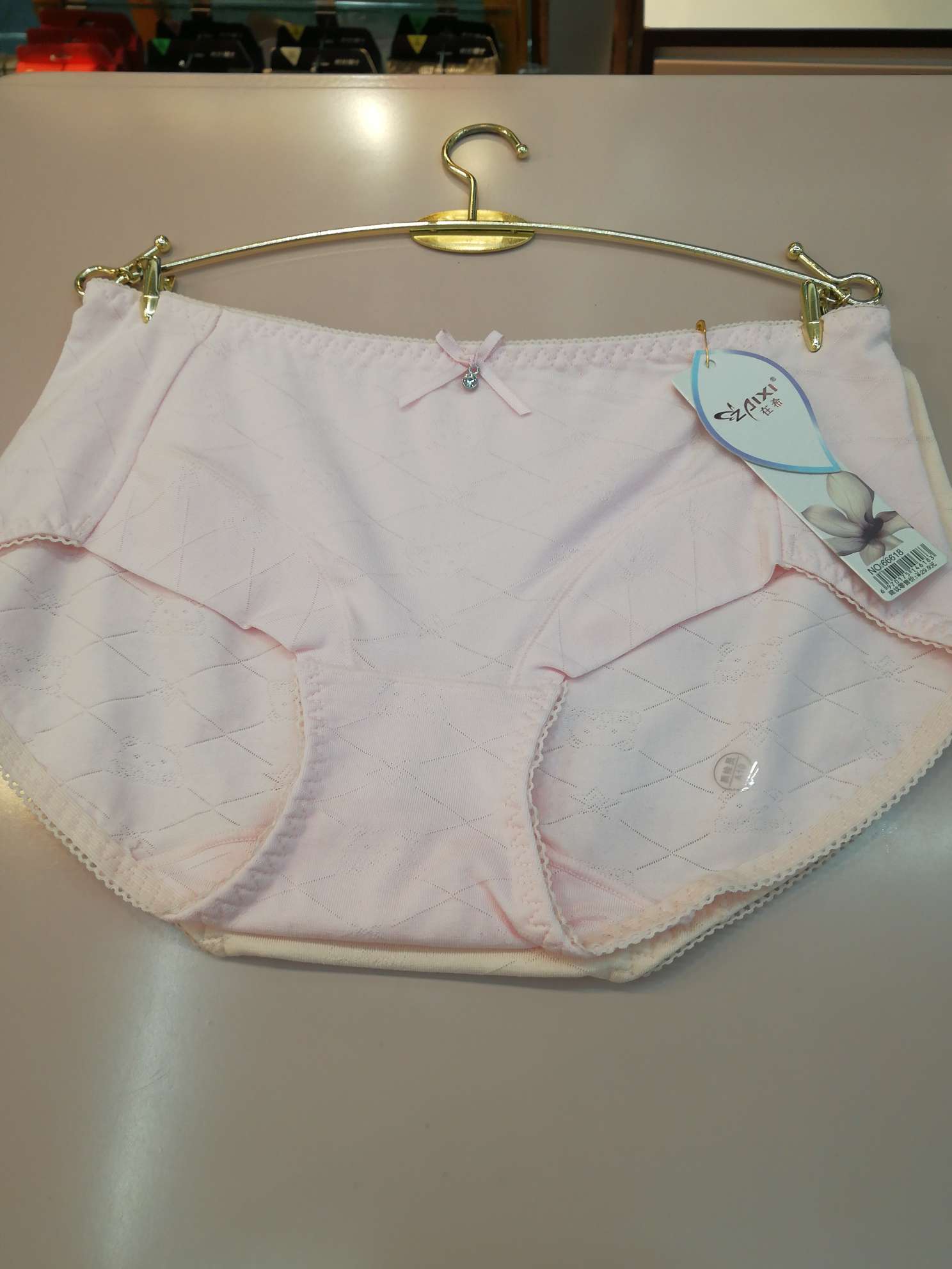 The girl's pants are pink in color