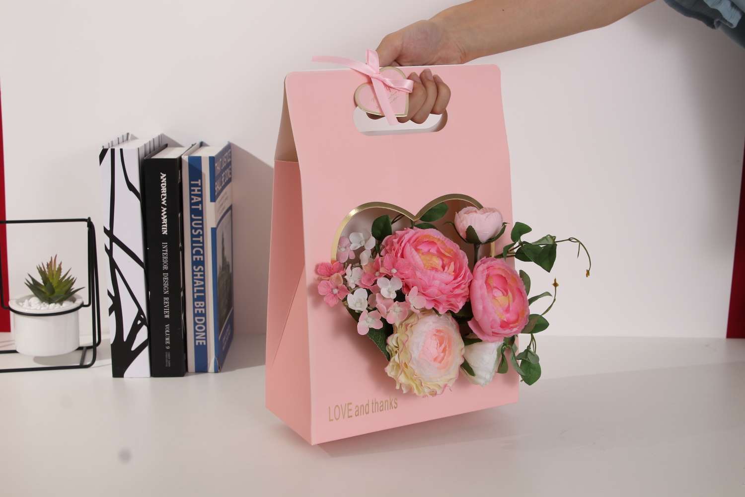 A heart-shaped hand-held flower basket