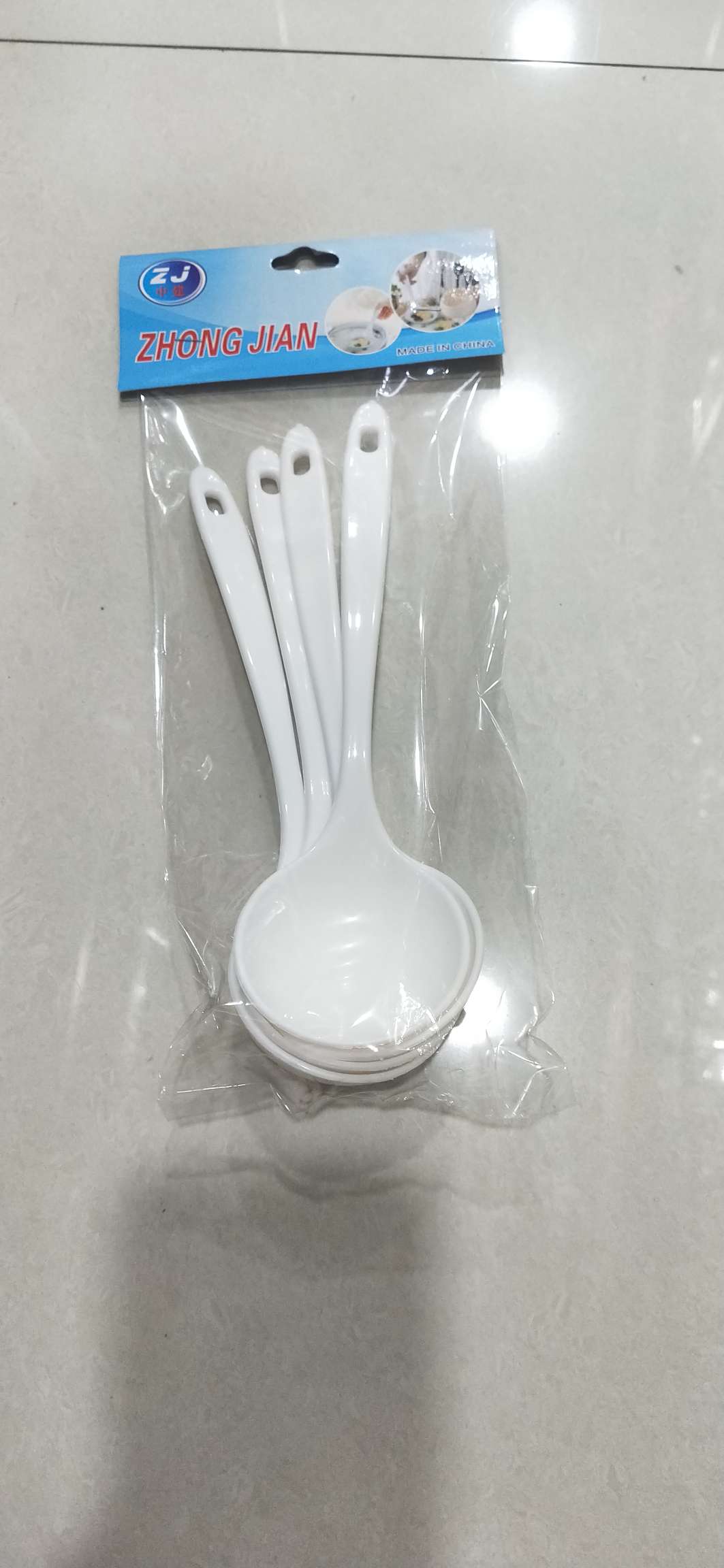 Four plastic spoons