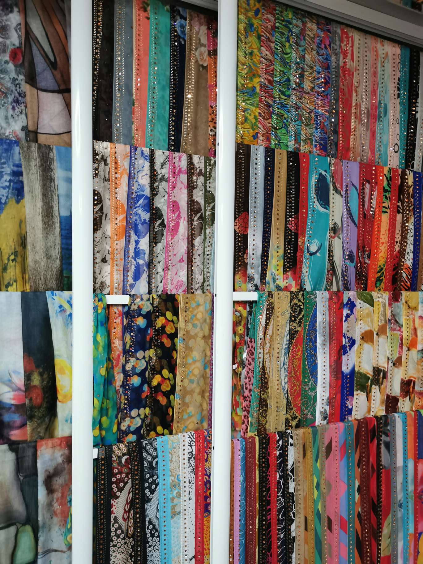 The headscarf is embossed with rhinestones and prints