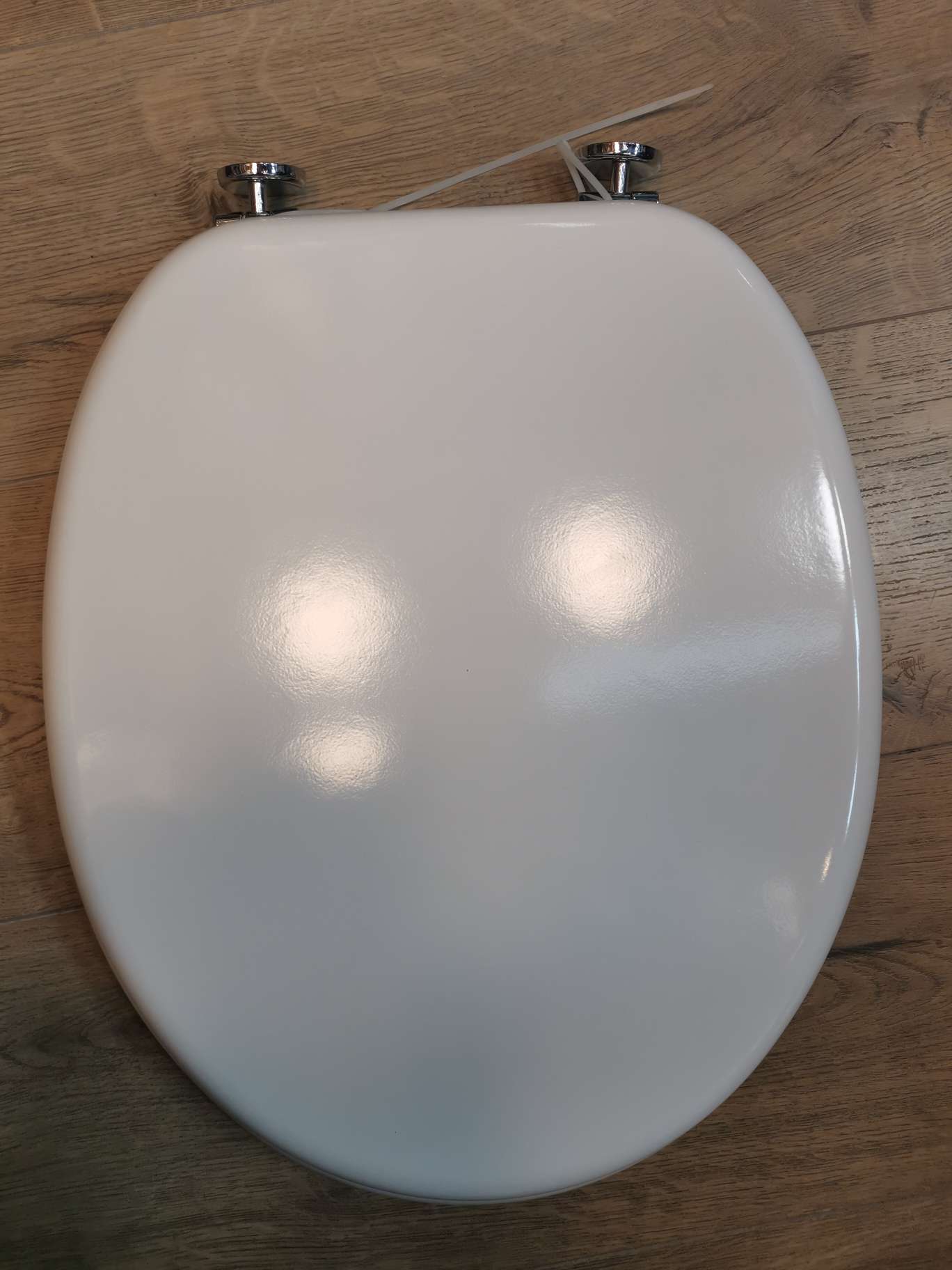 White spray-painted toilet seat thumbnail