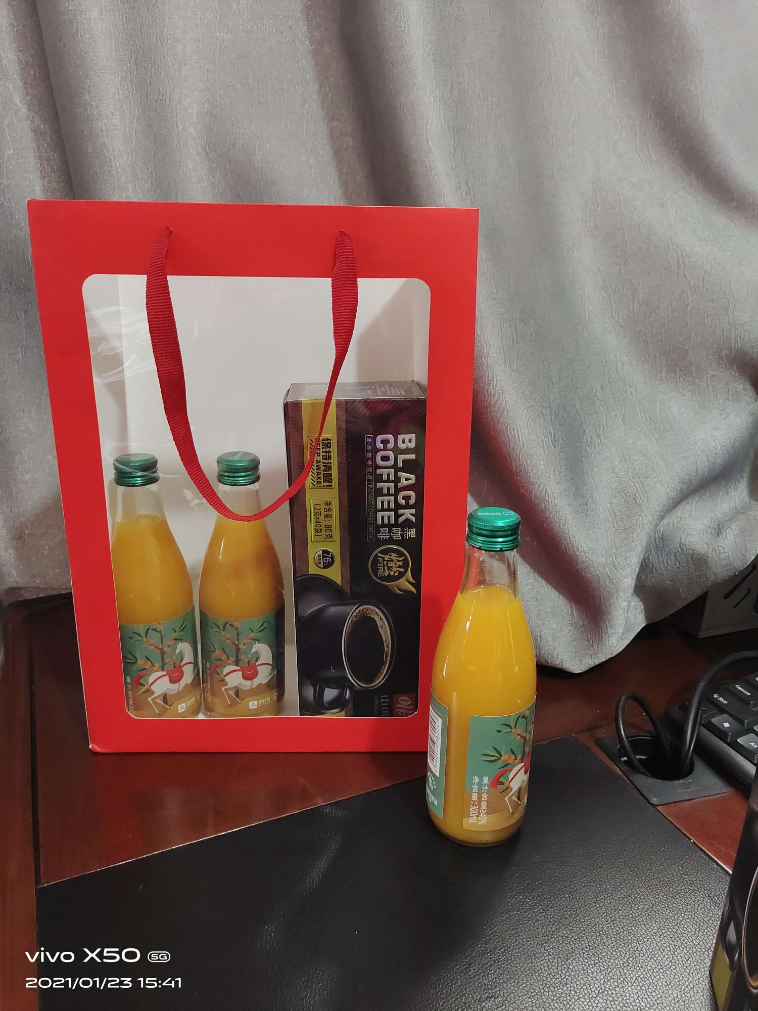 A bright red windowed gift bag Item Picture