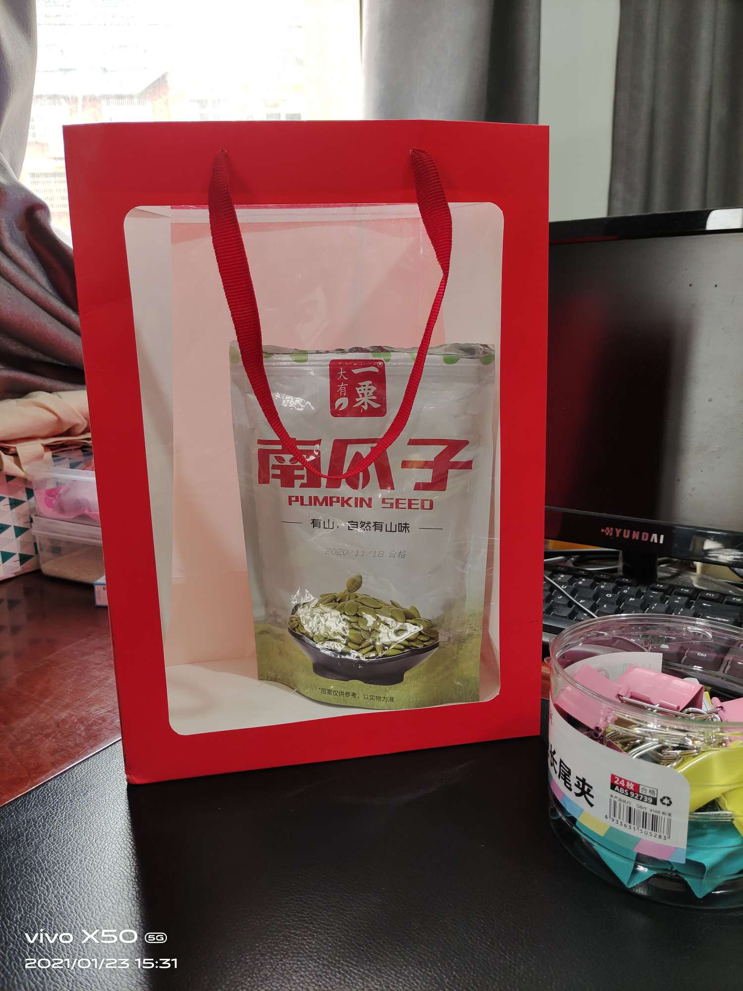 A bright red windowed gift bag detail image 1