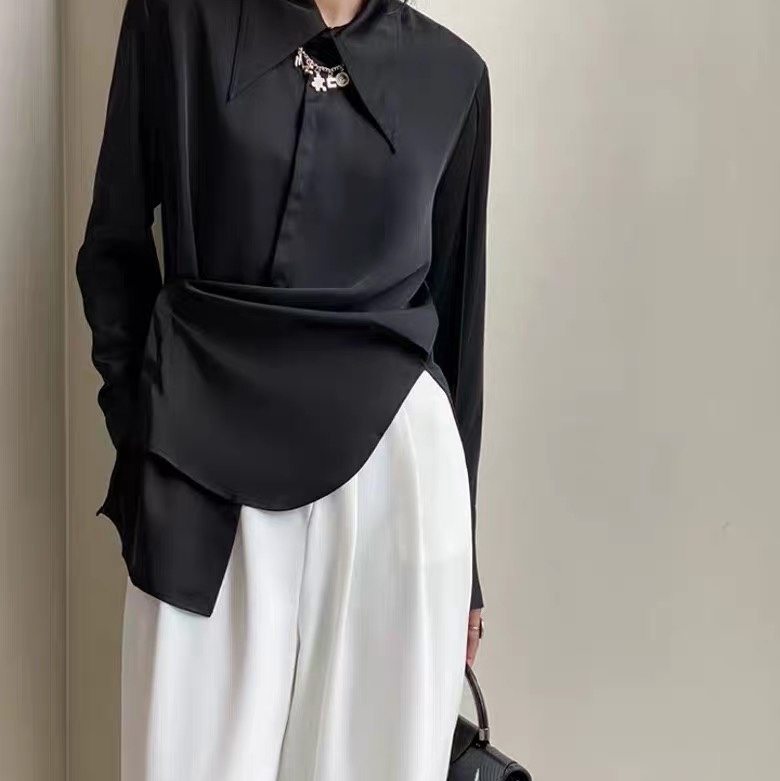 The shirt is black and white with smooth fabric