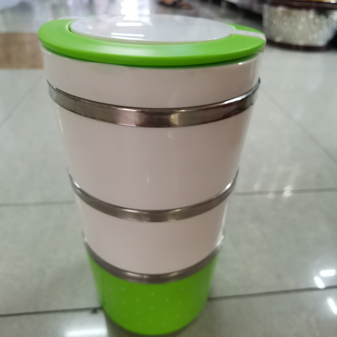 A 3-layer polka dot plastic round lunch box