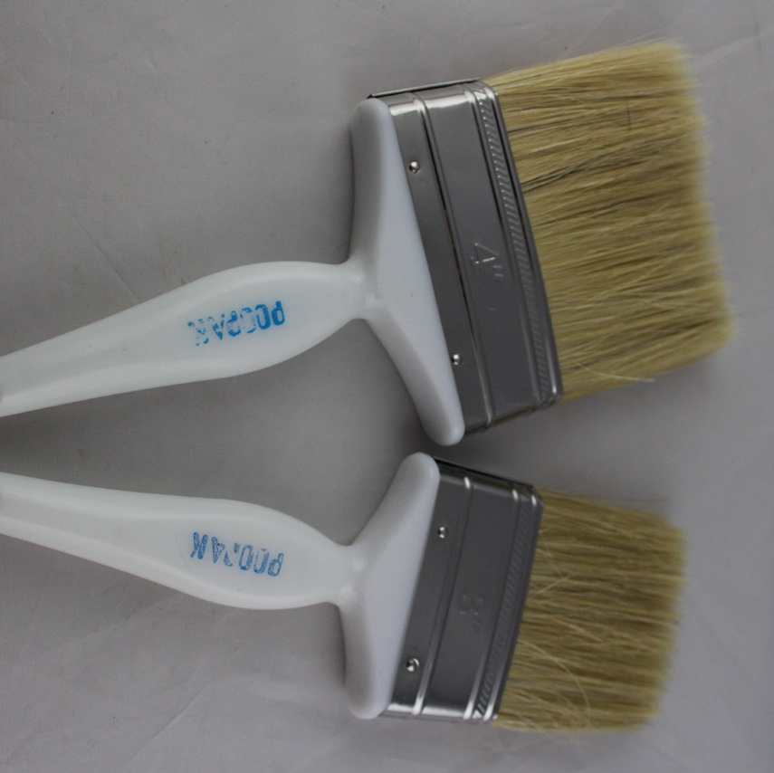 White plastic paint brush