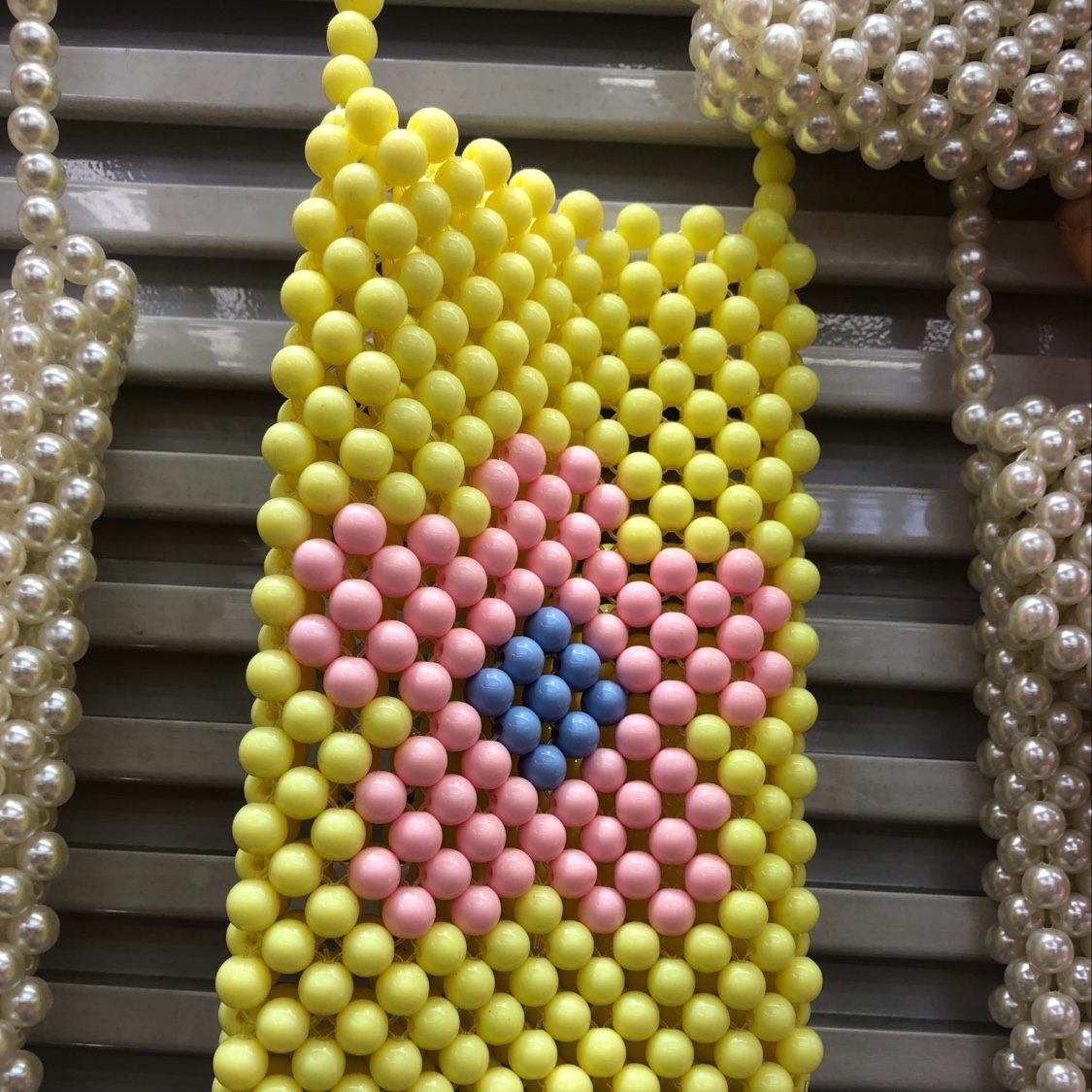 Handmade yellow small bags made of pearls