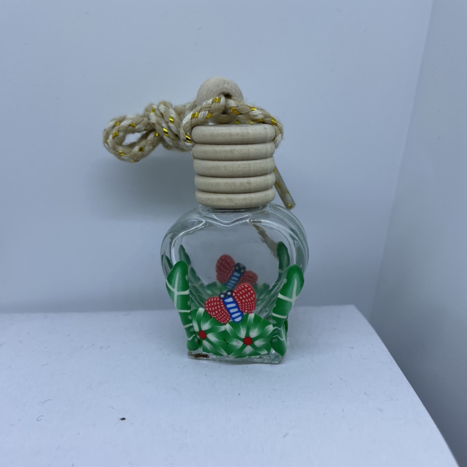 A half-pack soft terracotta flower flake perfume bottle with a wooden lid