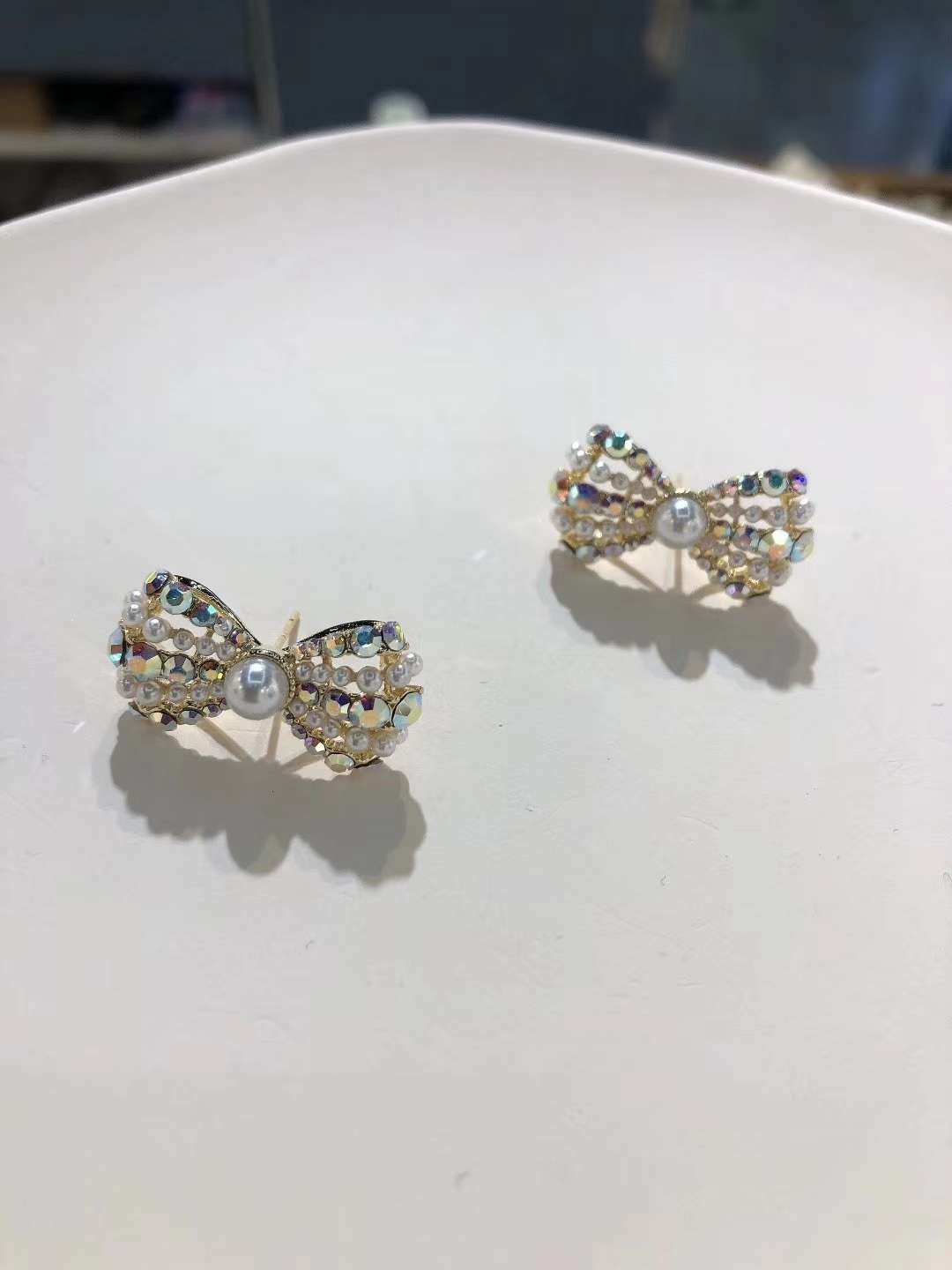 A new, stylish and simple pearl stud earring with a retro bow from Europe and America. It's a trendy and cool style earring for women on Instagram details Picture