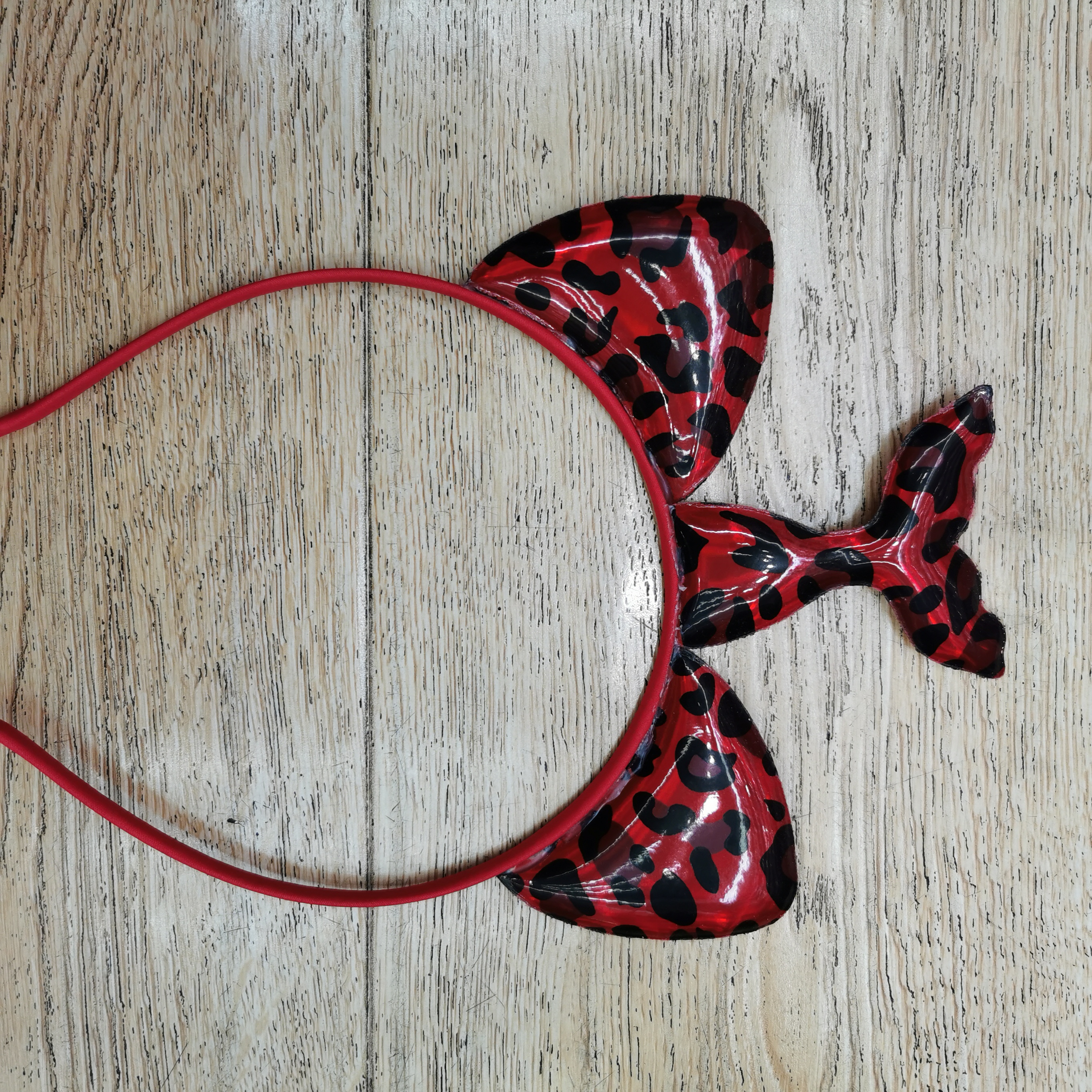 The leopard print mermaid headband is bright red