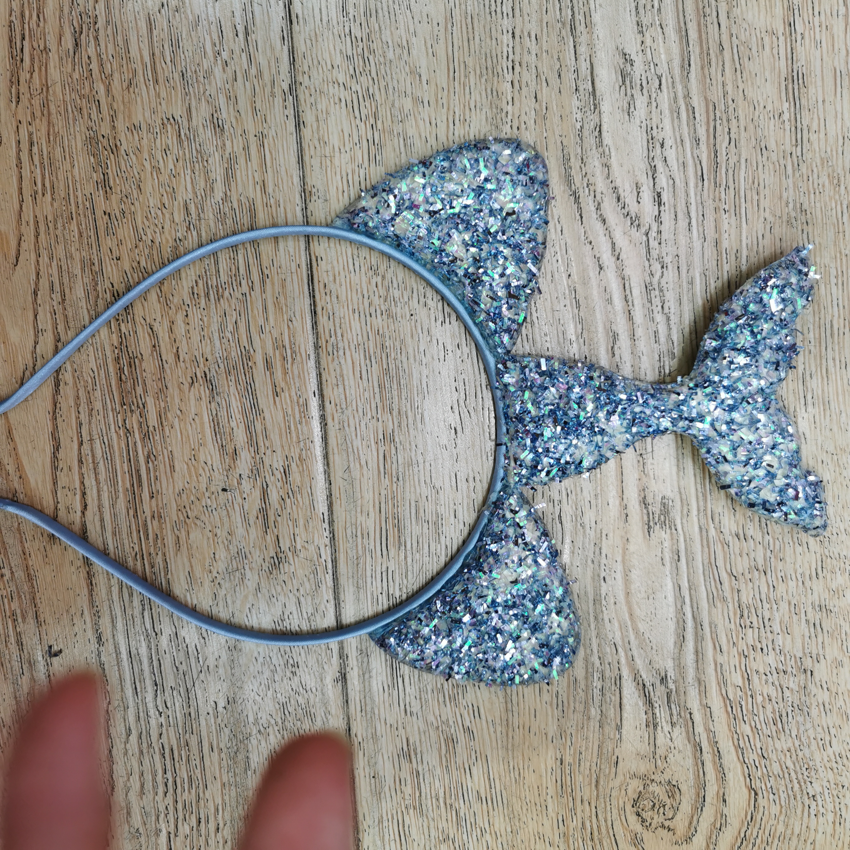 The mermaid headband is blue