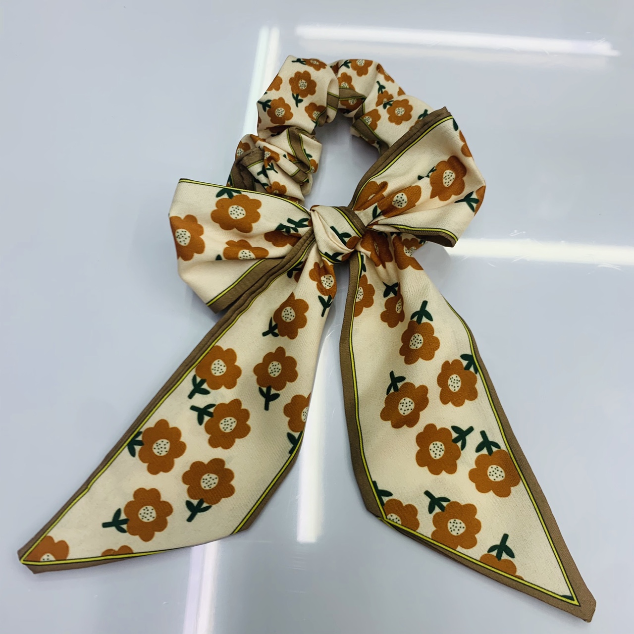 A small ribbon bow tie circle with a small sunflower