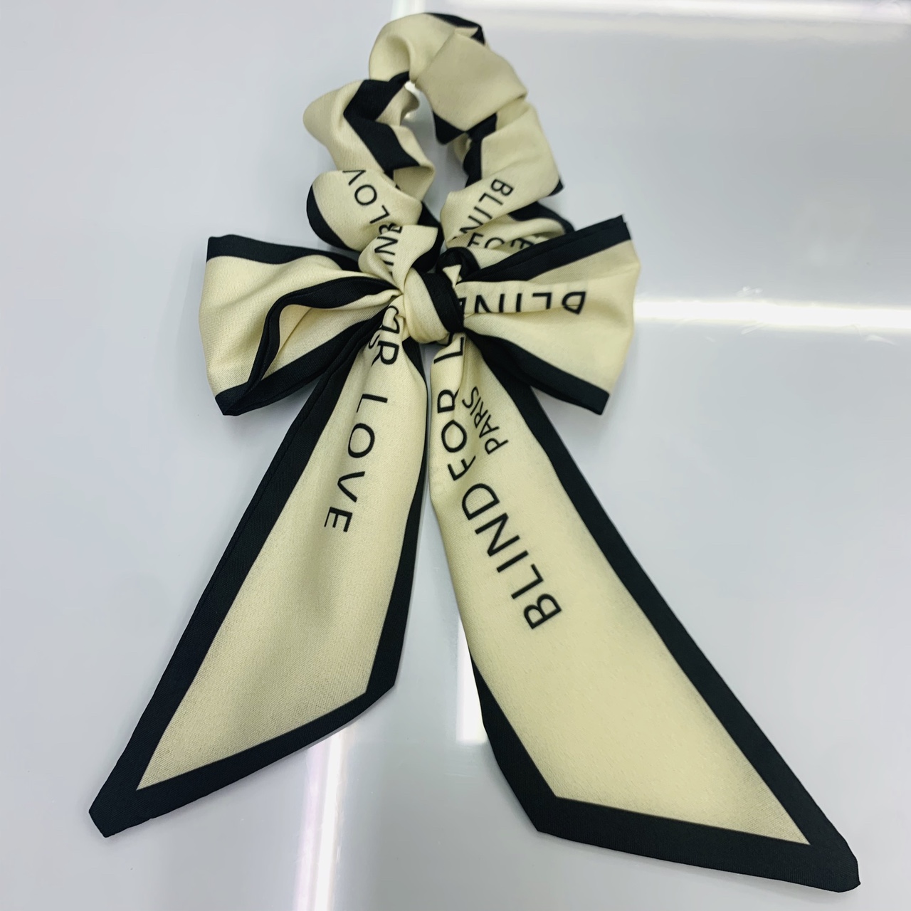 Small ribbon bow tie circle beige background English letters thumbnail