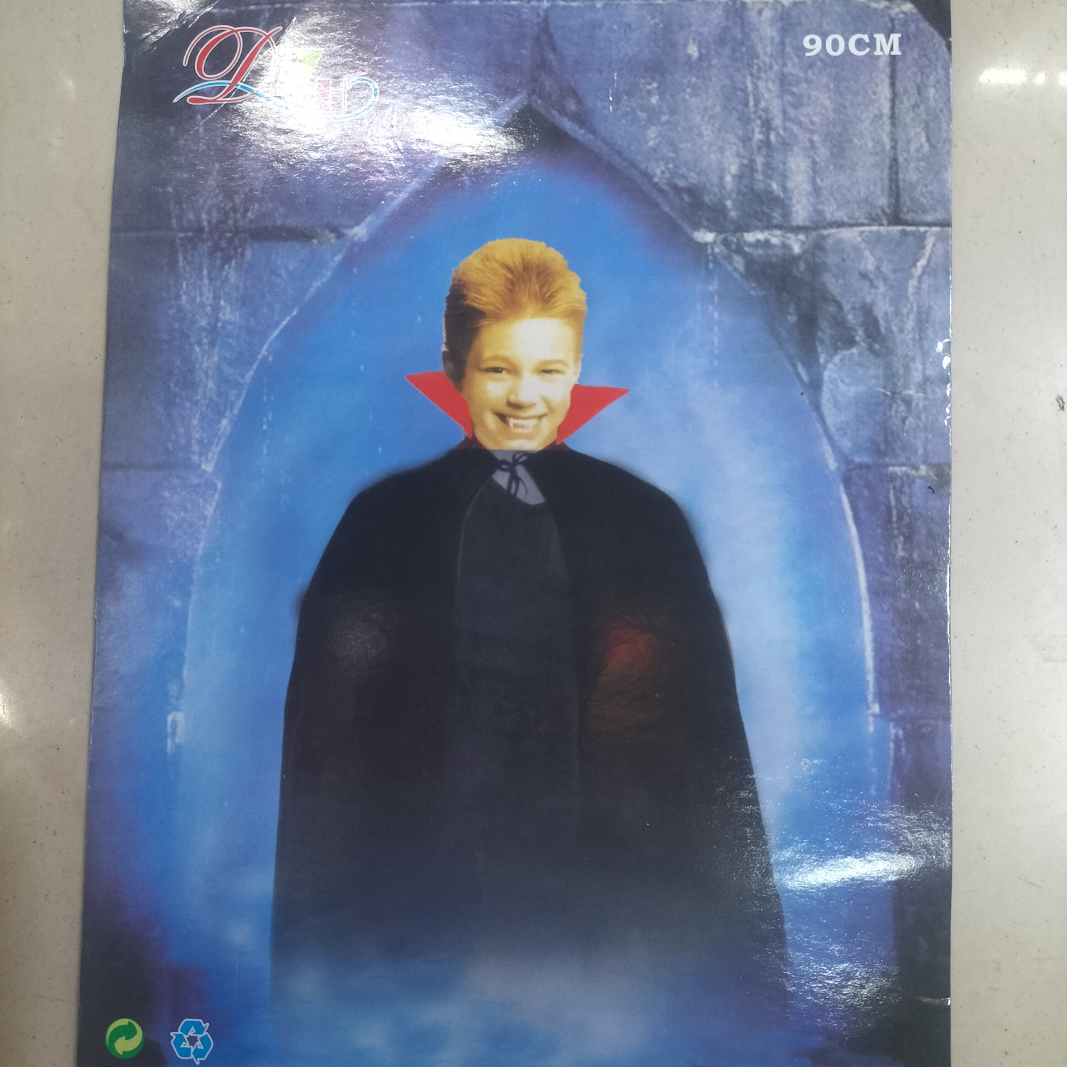 The child has a red collar and a black cape