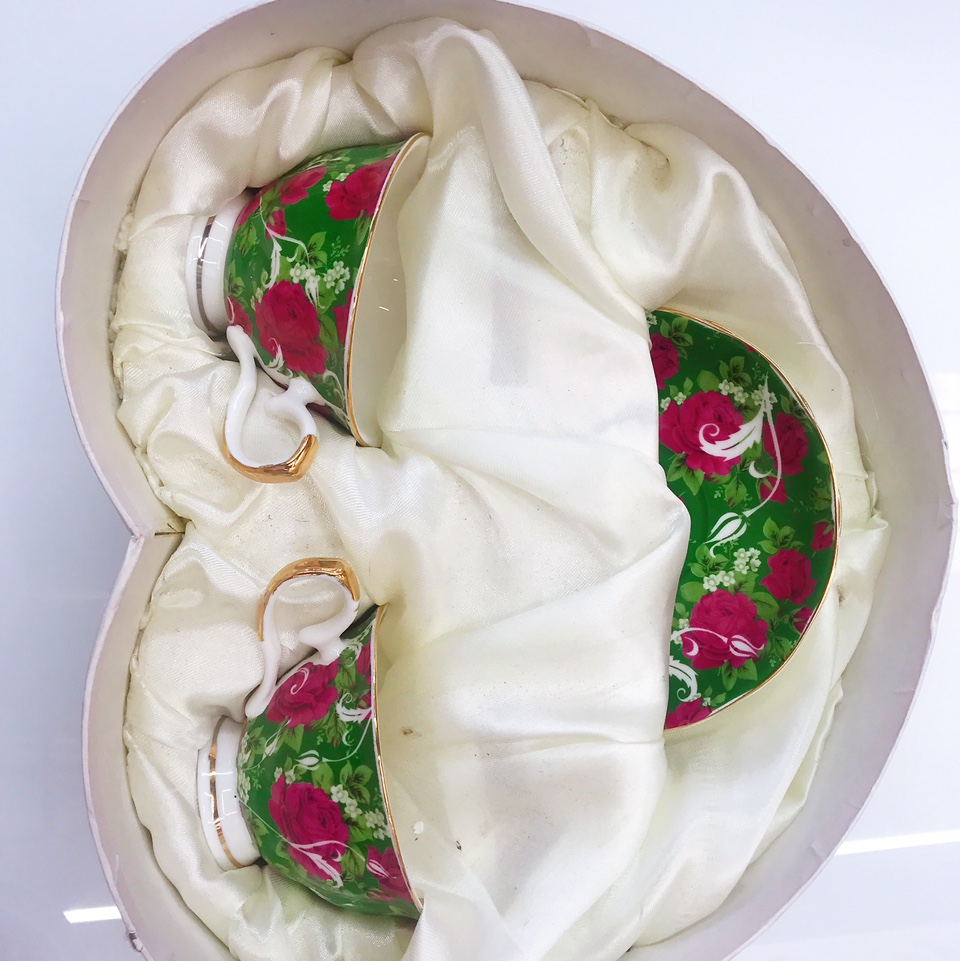 Two cups and two plates of green