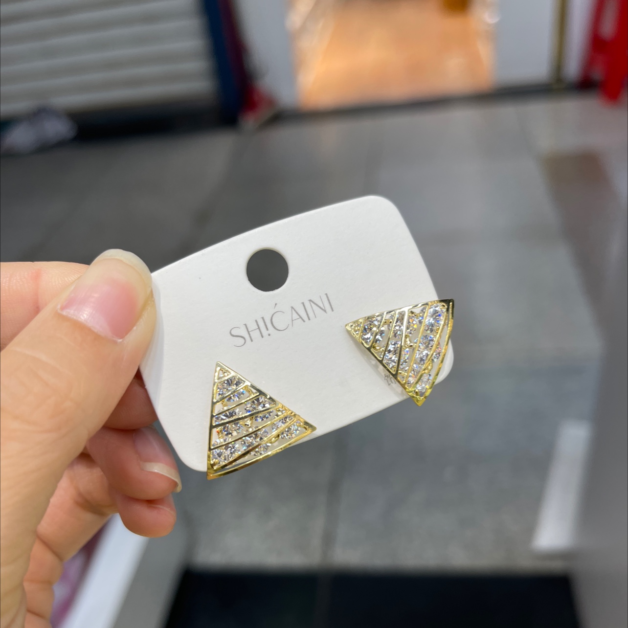Gold triangle earrings with diamonds