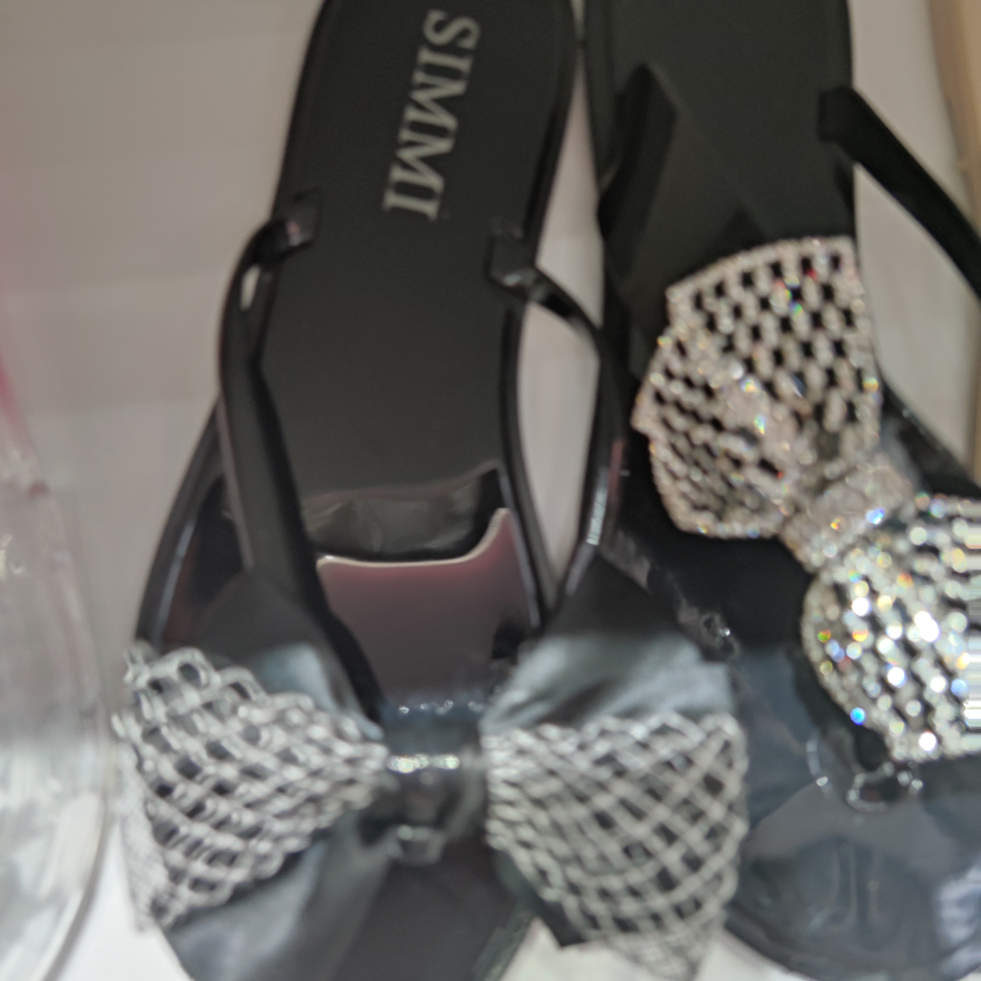 Black bow flip-flops