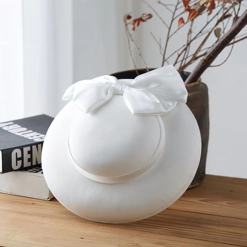 A versatile white top hat with Garish blue accessories