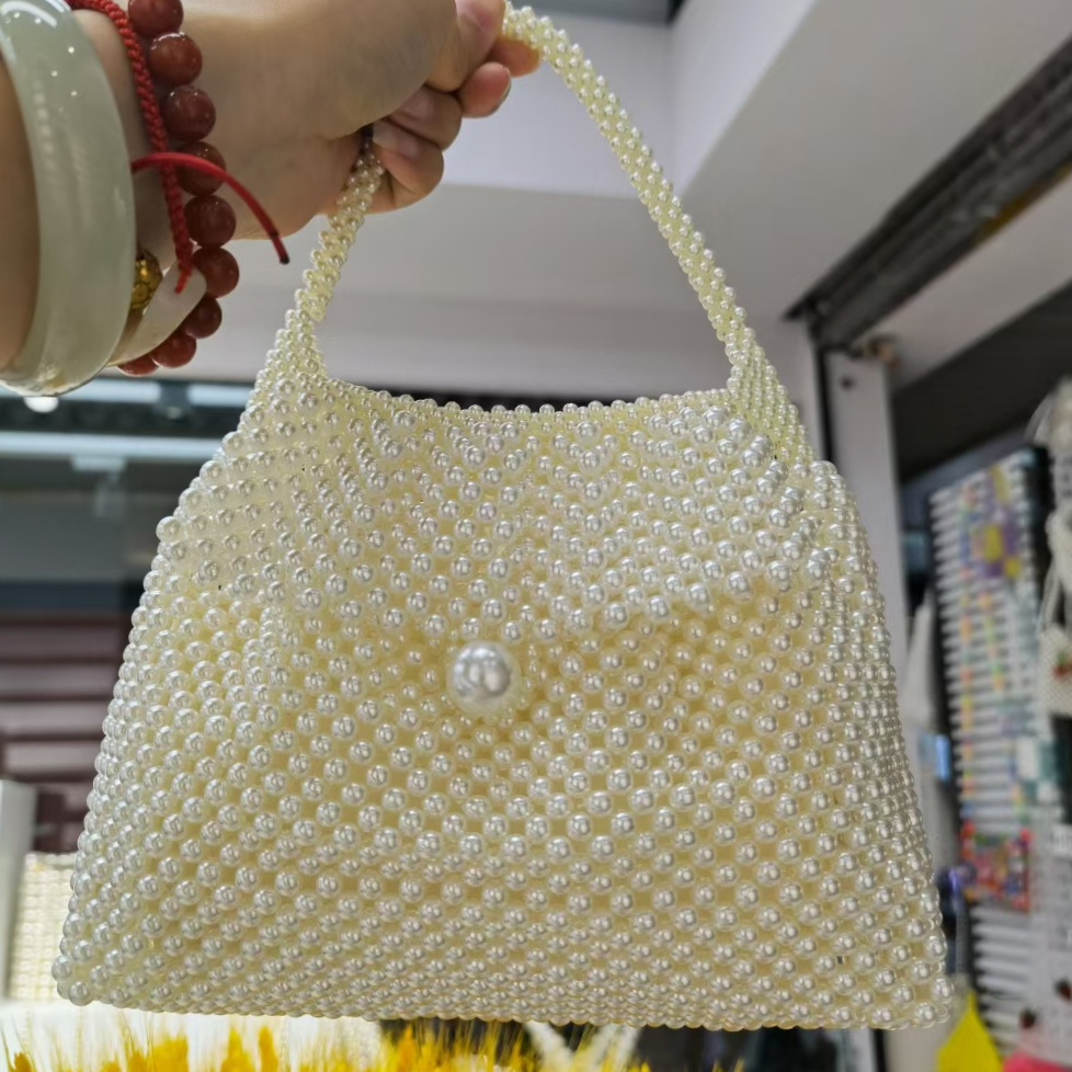The 2021 new trendy pearl crossbody bag with a unique design and hand-held square bag is a super popular women's bag for summer
