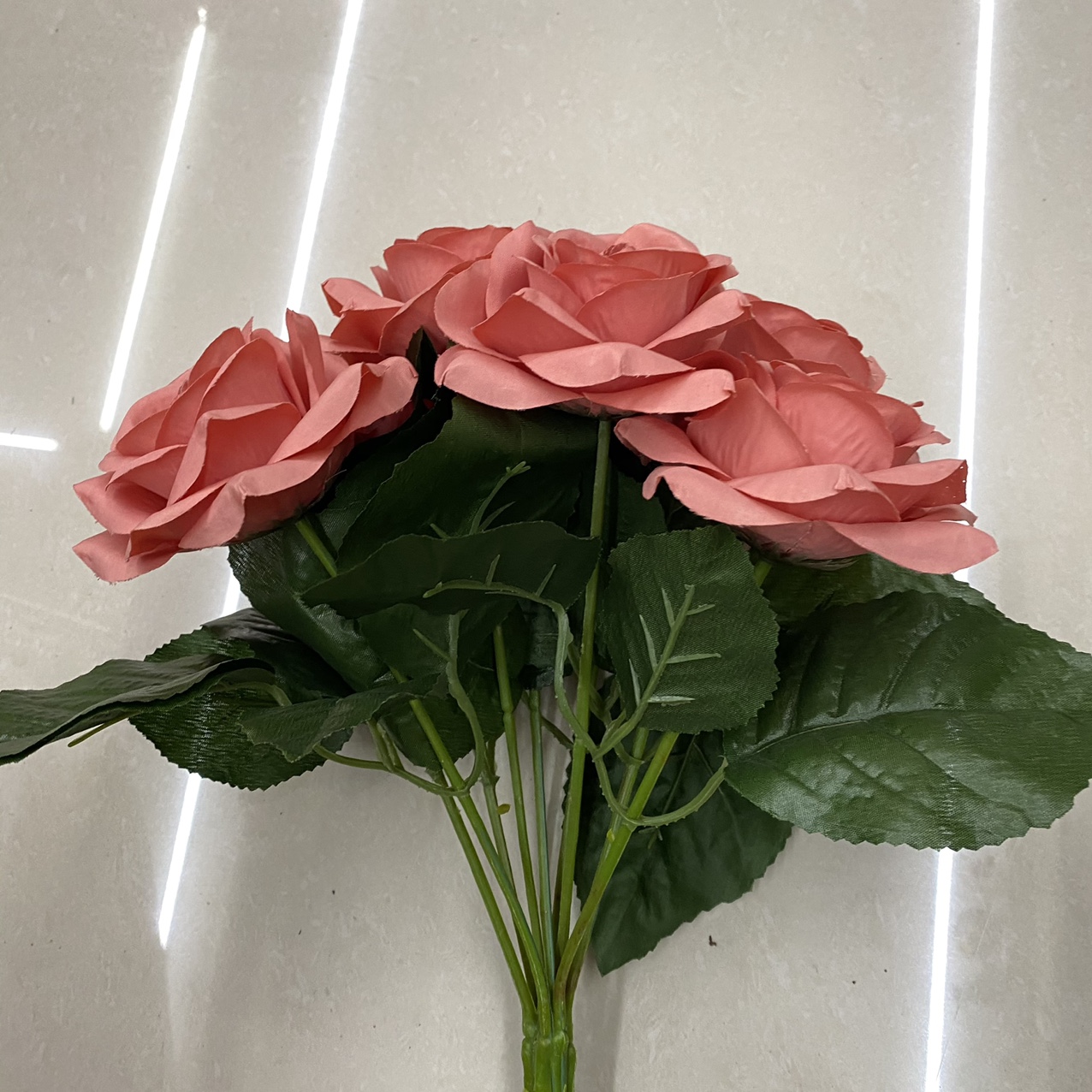 Rubber red rose bouquet with green leaves