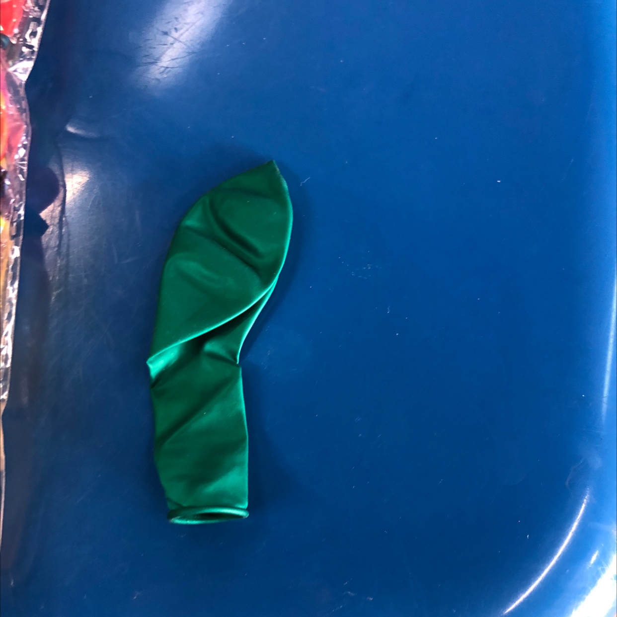 The pearlescent balloon is dark green