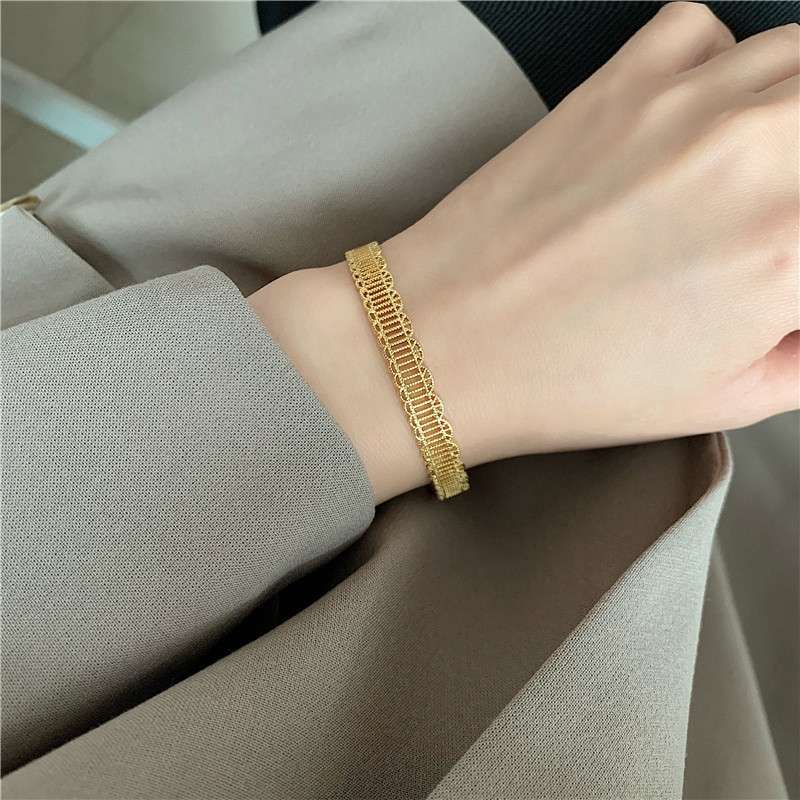 The cool and niche design of the golden hollowed-out pattern open bracelet and wristband on Instagram exudes a high-end feel and is a trendy internet-famous jewelry details Picture