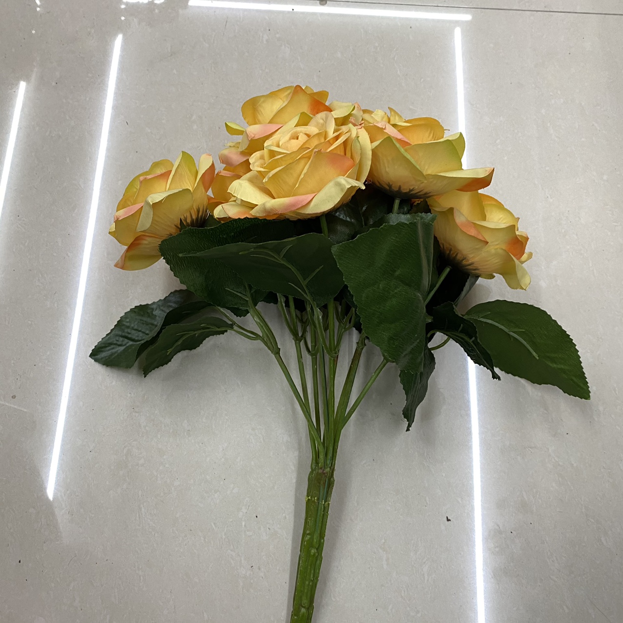 Yellow rose bouquet with green leaves