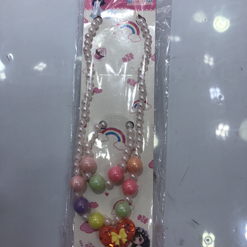 The children's necklace is pearl white