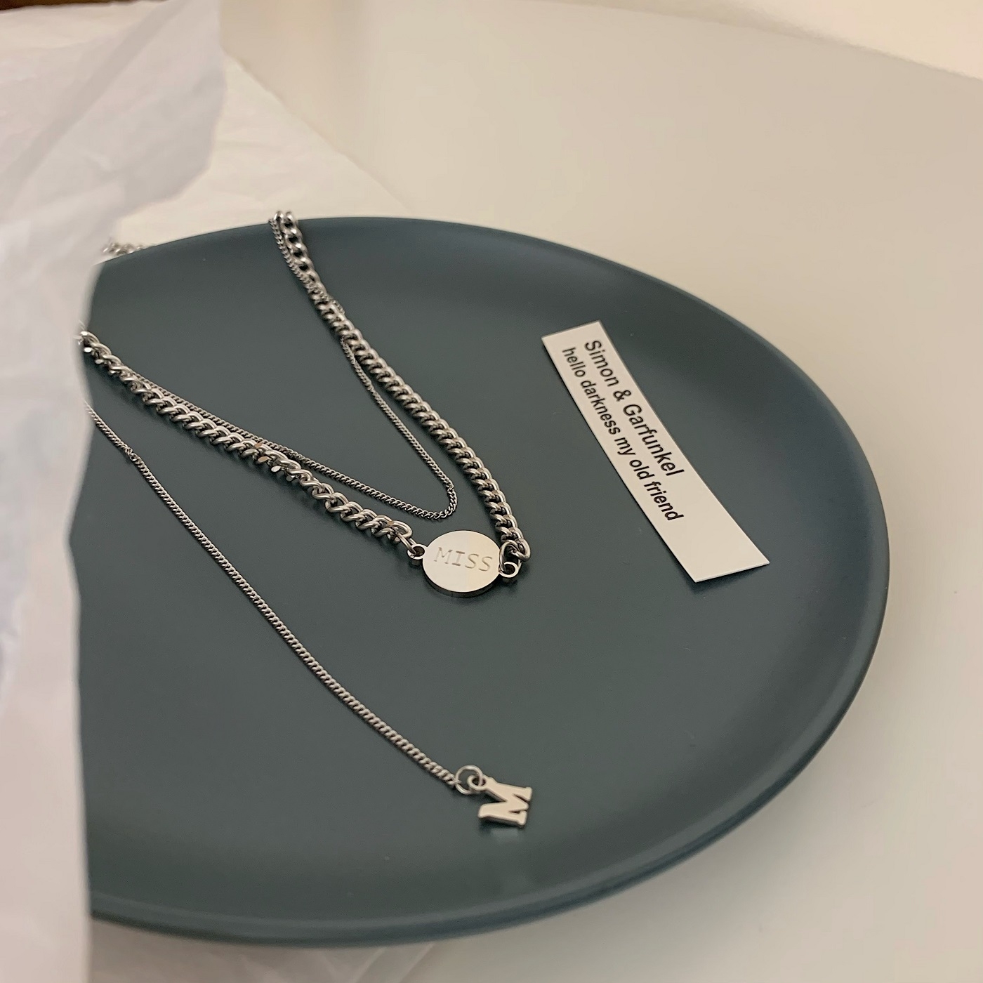 The "Korean and Korean Cold Style" double-layered round plate MISS titanium steel necklace with a niche design sense for both men and women is a trend of popular collarbone chains